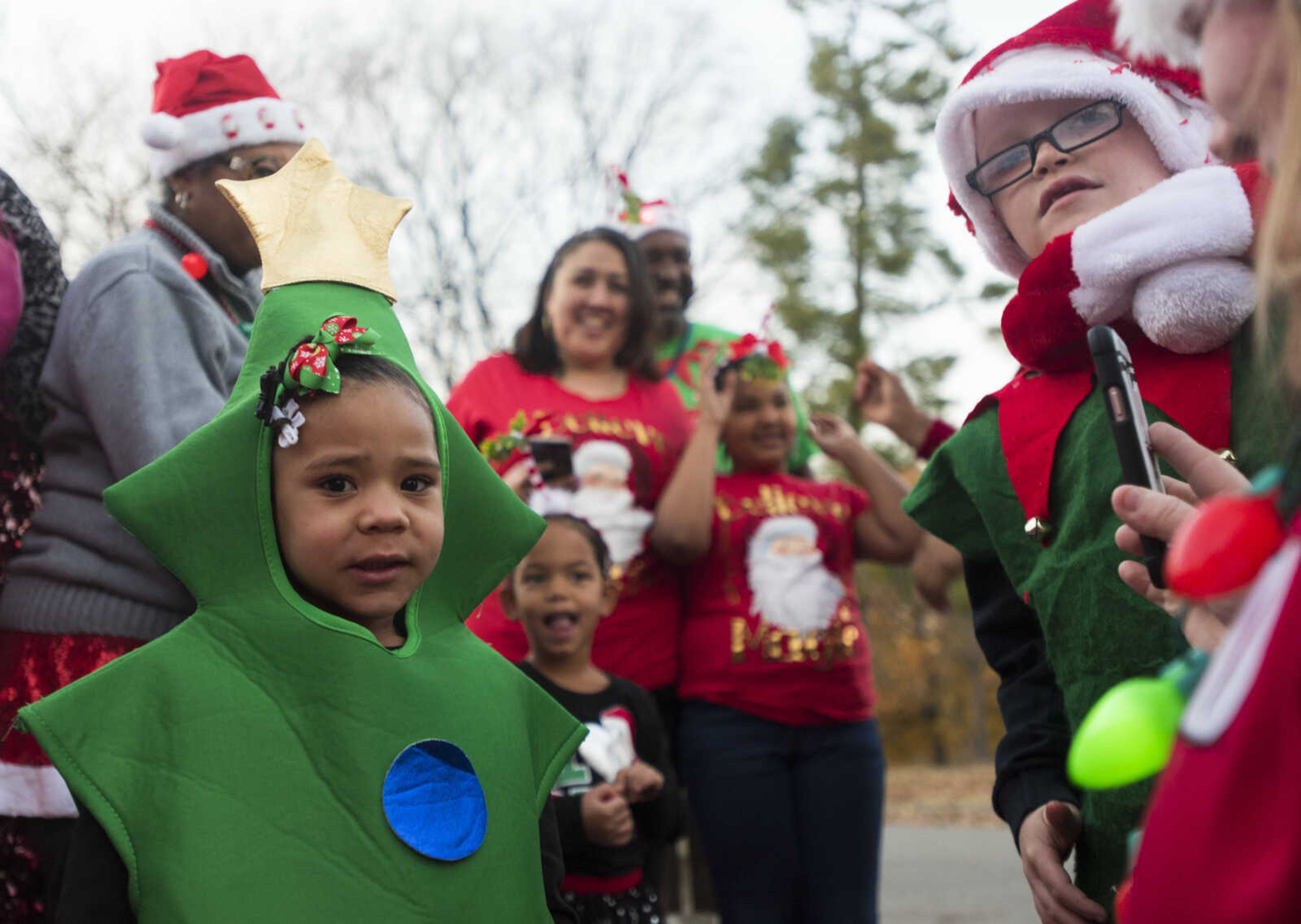 Illyara Webb, 4, makes a nervous face after putting on a Christmas tree costume to wear while walking in the 26th annual Parade of Lights with the Isle Casino float Nov. 26, 2017, in Cape Girardeau.