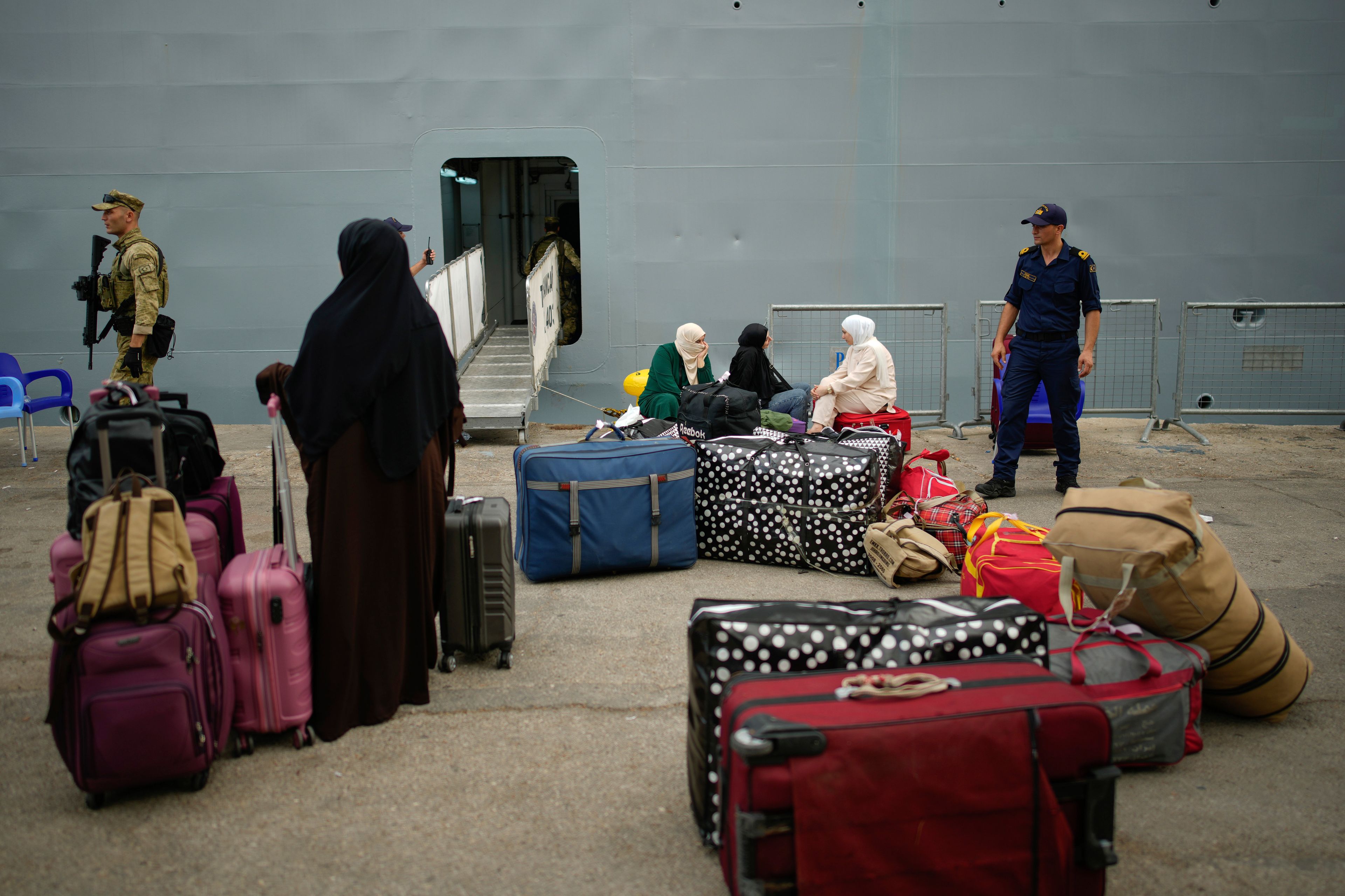 People, mostly Turkish citizens, wait to go on board of a Turkish military ship evacuating them from Lebanon to Turkey, in Beirut port, on Thursday, Oct. 10, 2024. (AP Photo/Emrah Gurel)