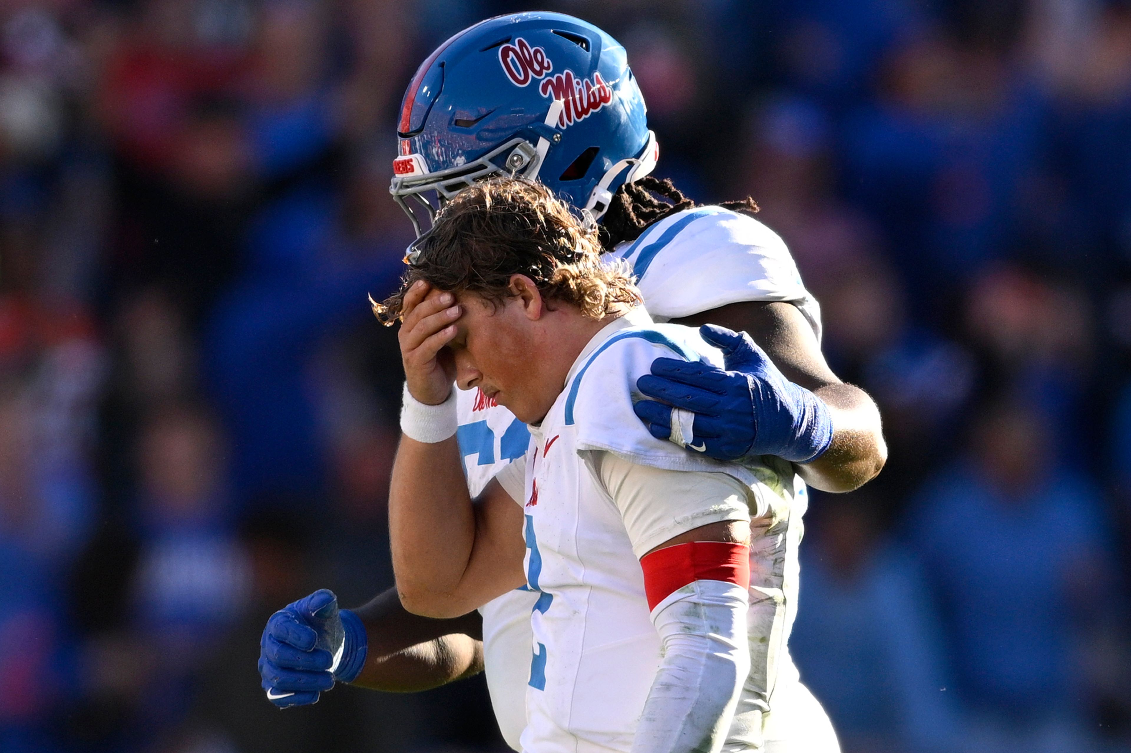 Mississippi quarterback Jaxson Dart (2) is consoled by offensive lineman Diego Pounds, rear, after throwing an interception late in the second half of an NCAA college football game against Florida, Saturday, Nov. 23, 2024, in Gainesville, Fla. (AP Photo/Phelan M. Ebenhack)