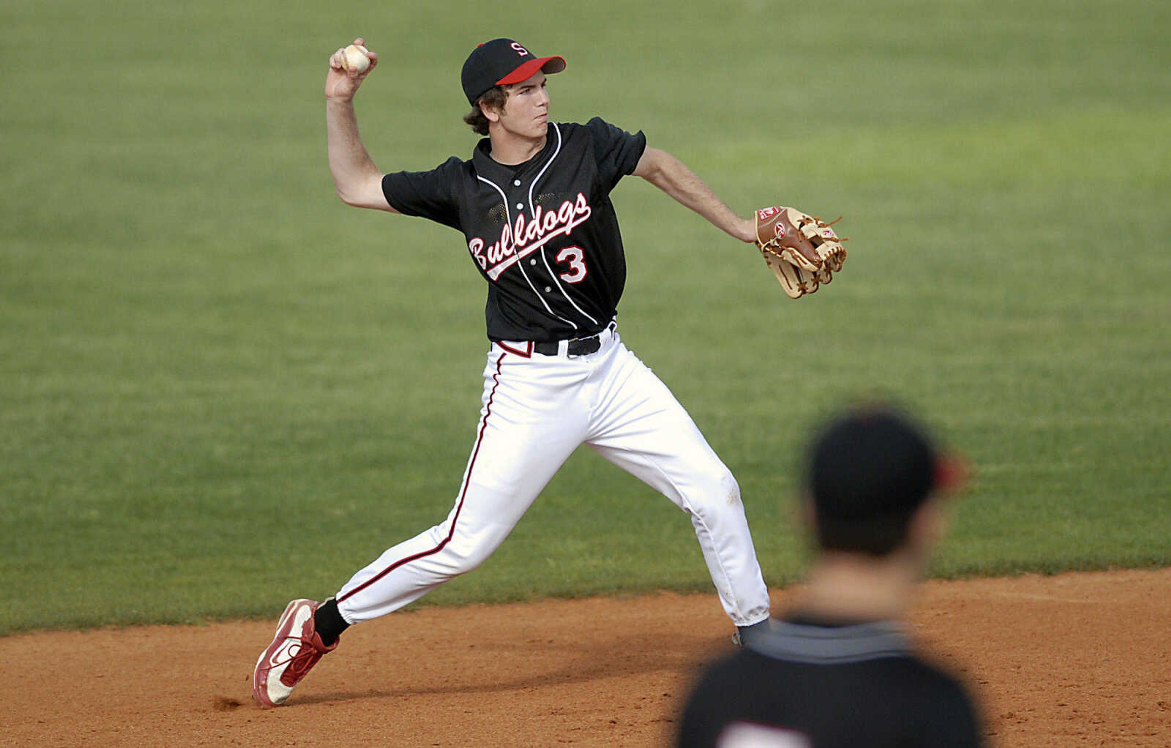 Sikeston shortstop Jordan Williams throws to first for a force out Tuesday, April 28, 2009, in Cape Girardeau.