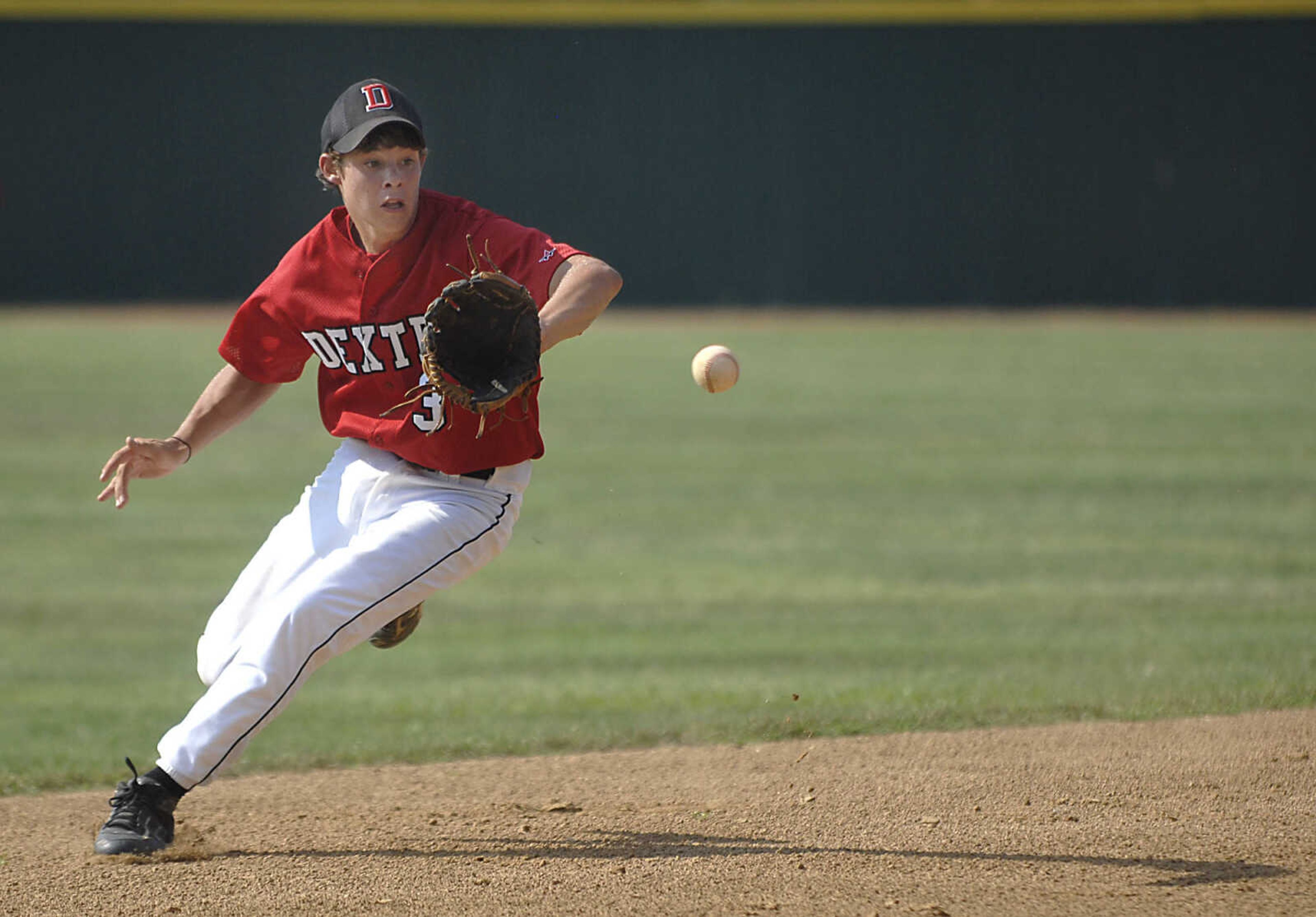 KIT DOYLE ~ kdoyle@semissourian.com
Dexter shortstop Brandon Stofer grabs a high bouncer Monday, July 13, 2009, at Capaha Field.