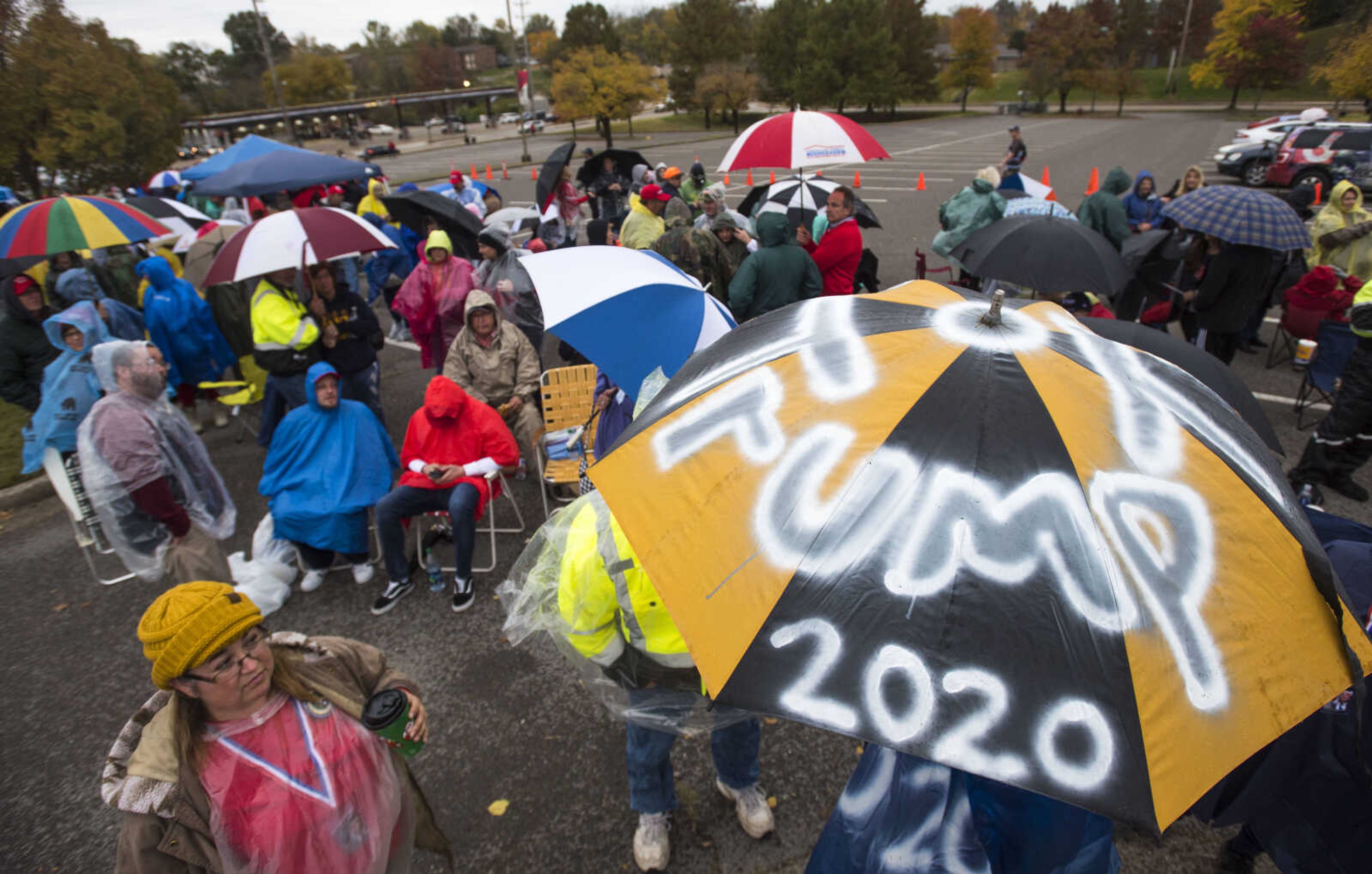 "Trump 2020" is spray painted onto the umbrella of Joe Sells of Dexter, Missouri, as Trump supporters stand in line for a Make America Great Again rally Monday, Nov. 5, 2018, at the Show Me Center in Cape Girardeau.