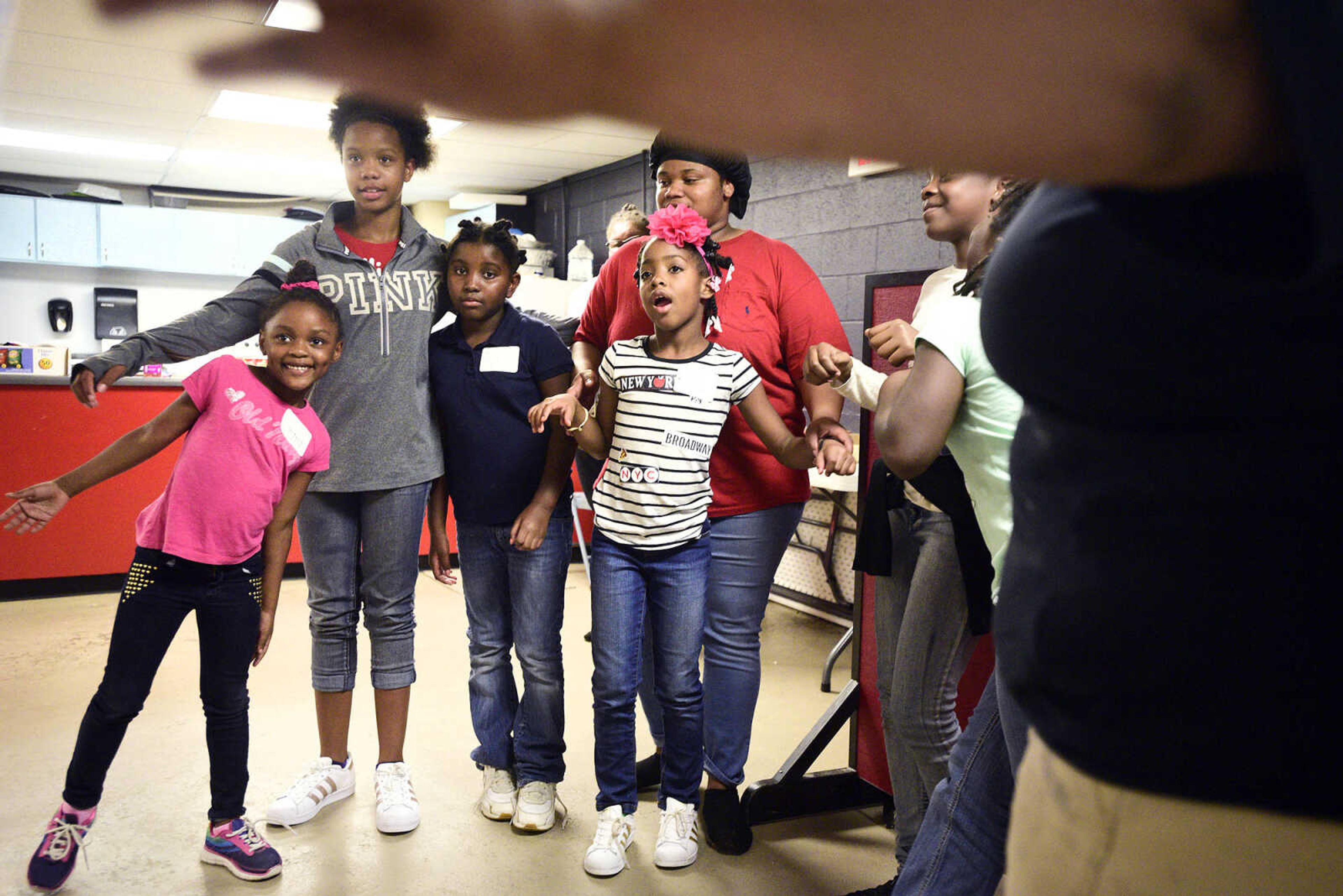 From left to right, Lauren Washington, Kaylin Maney, Nala Maney, Kamajah Hamilton and Chamika Moore dance in a circle on Monday, Aug. 14, 2017, during the Salvation Army's after school program at The Bridge Outreach Center in Cape Girardeau.