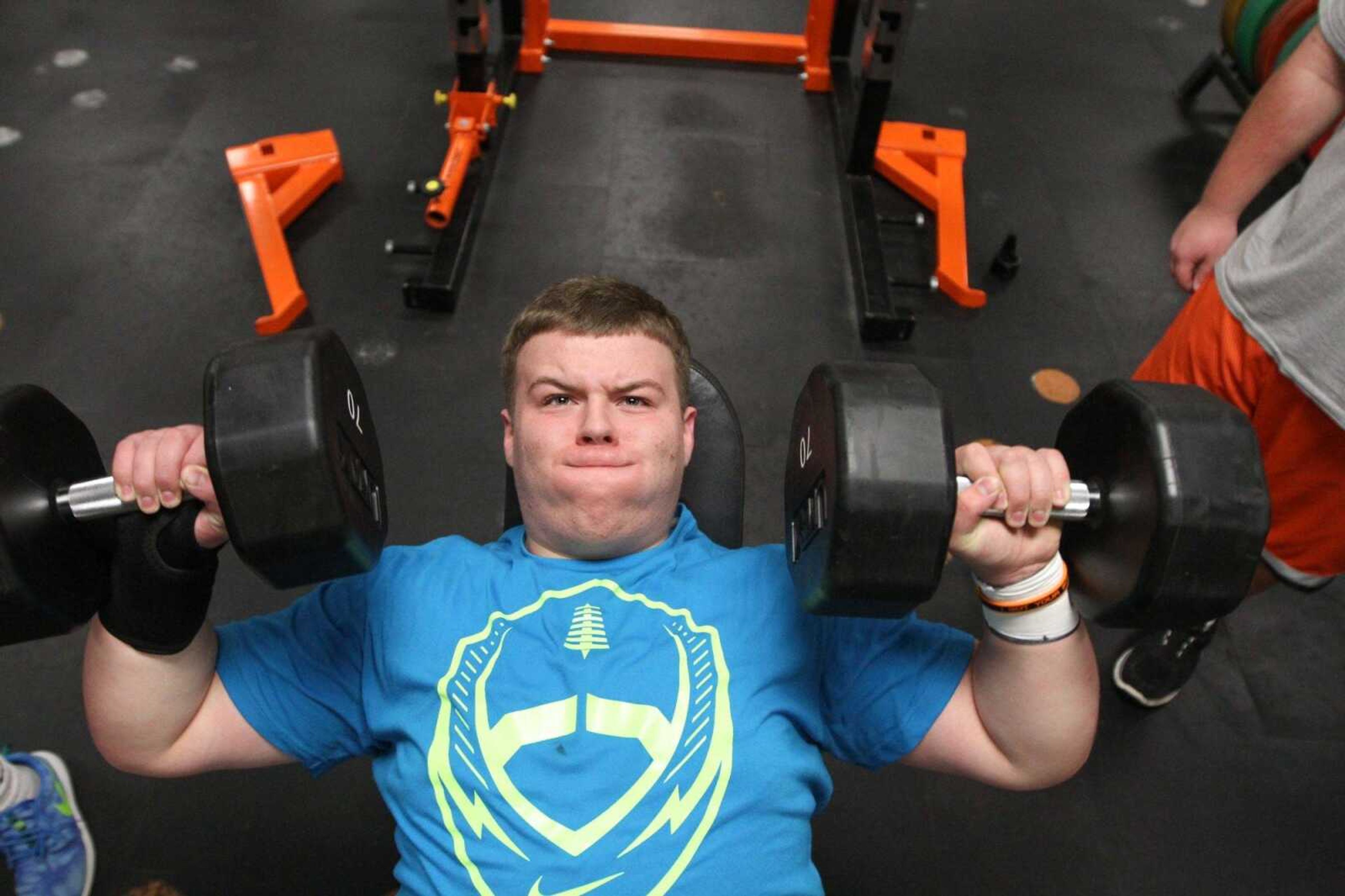 Cape Central's Jacob Holter lifts dumbbells with his teammates during a weight lifting workout at Cape Central High School  Wednesday, April 8, 2015. (Glenn Landberg)