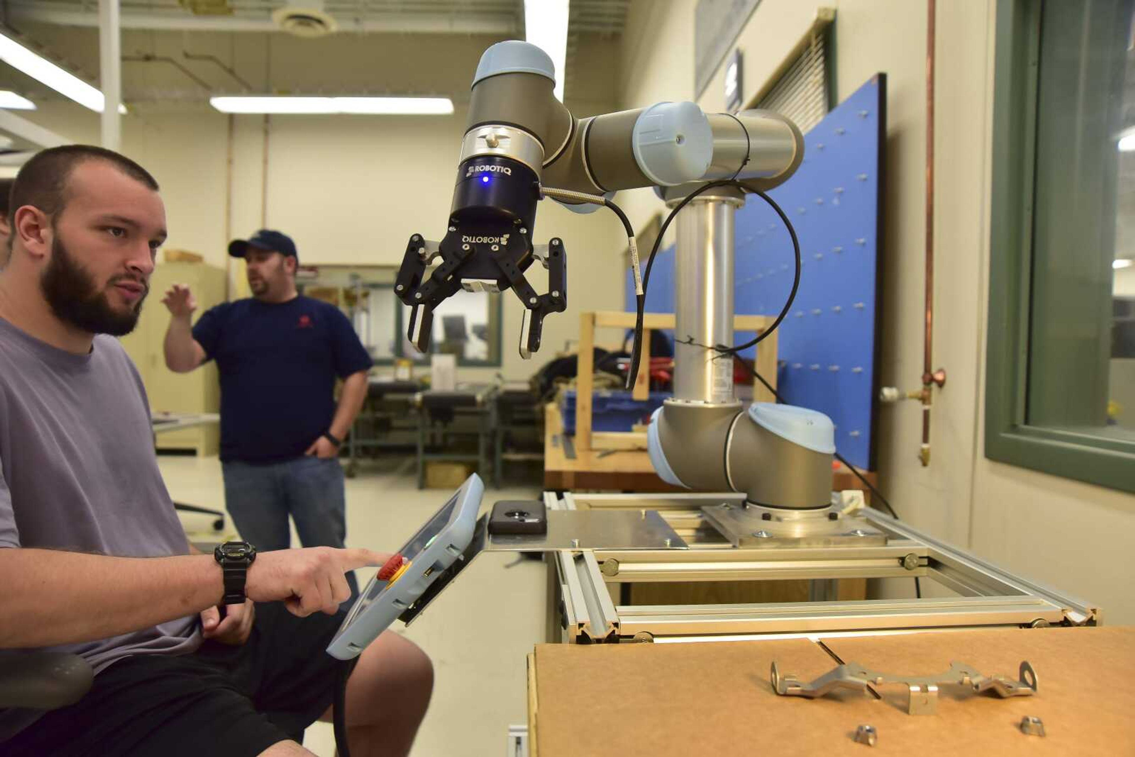 Billy Dasher, a mechanical and manufacturing major at Southeast Missouri State University, goes over controls of a robotic arm to move individual parts from one table to another Thursday during class in the Advanced Manufacturing Lab at the university's polytech building in Cape Girardeau.