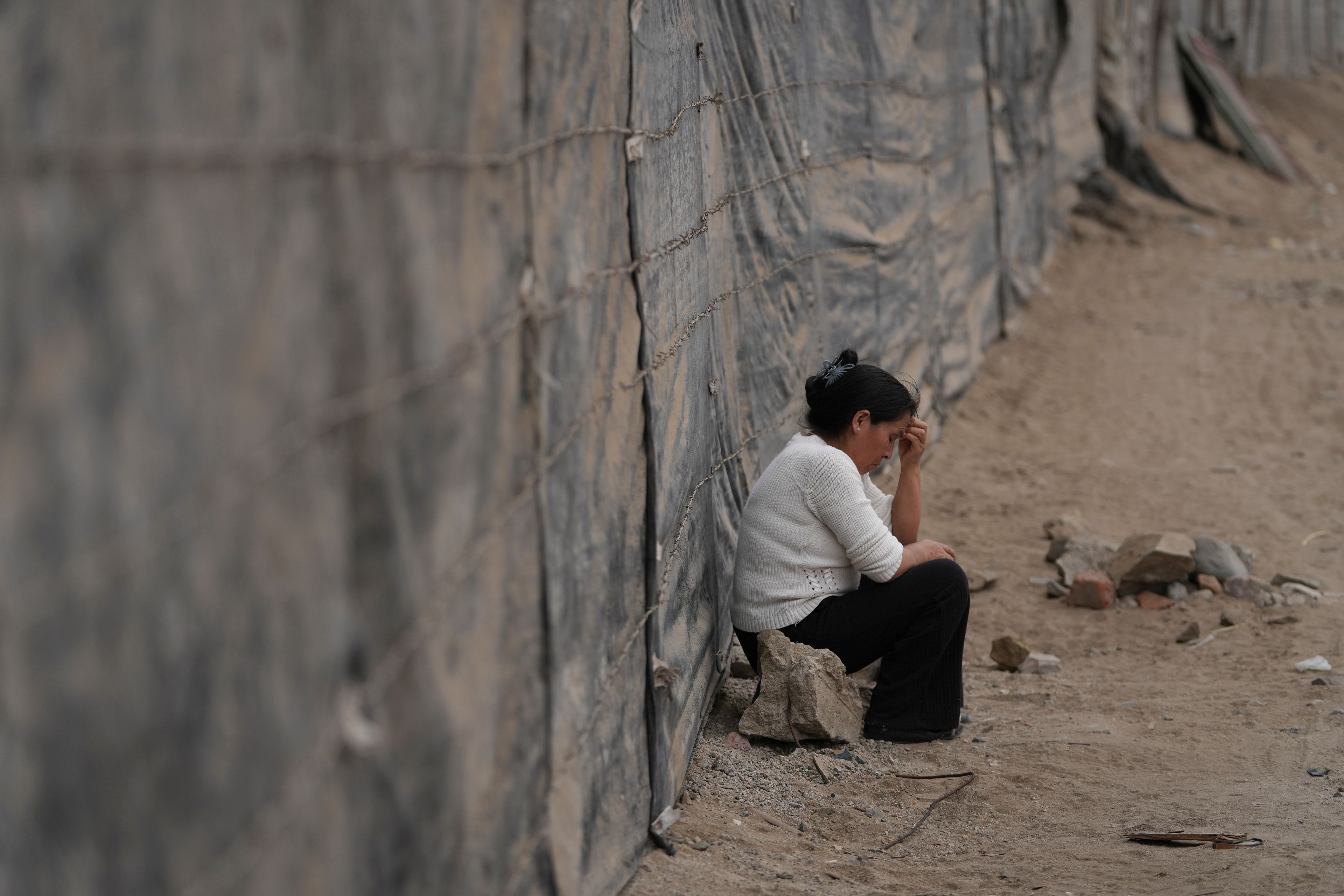 Filena Celestina gestures during a conversation about problems in the Senor de la Soledad shantytown near a Chinese-funded port in Chancay, Peru, Tuesday, Nov. 12, 2024. (AP Photo/Silvia Izquierdo)