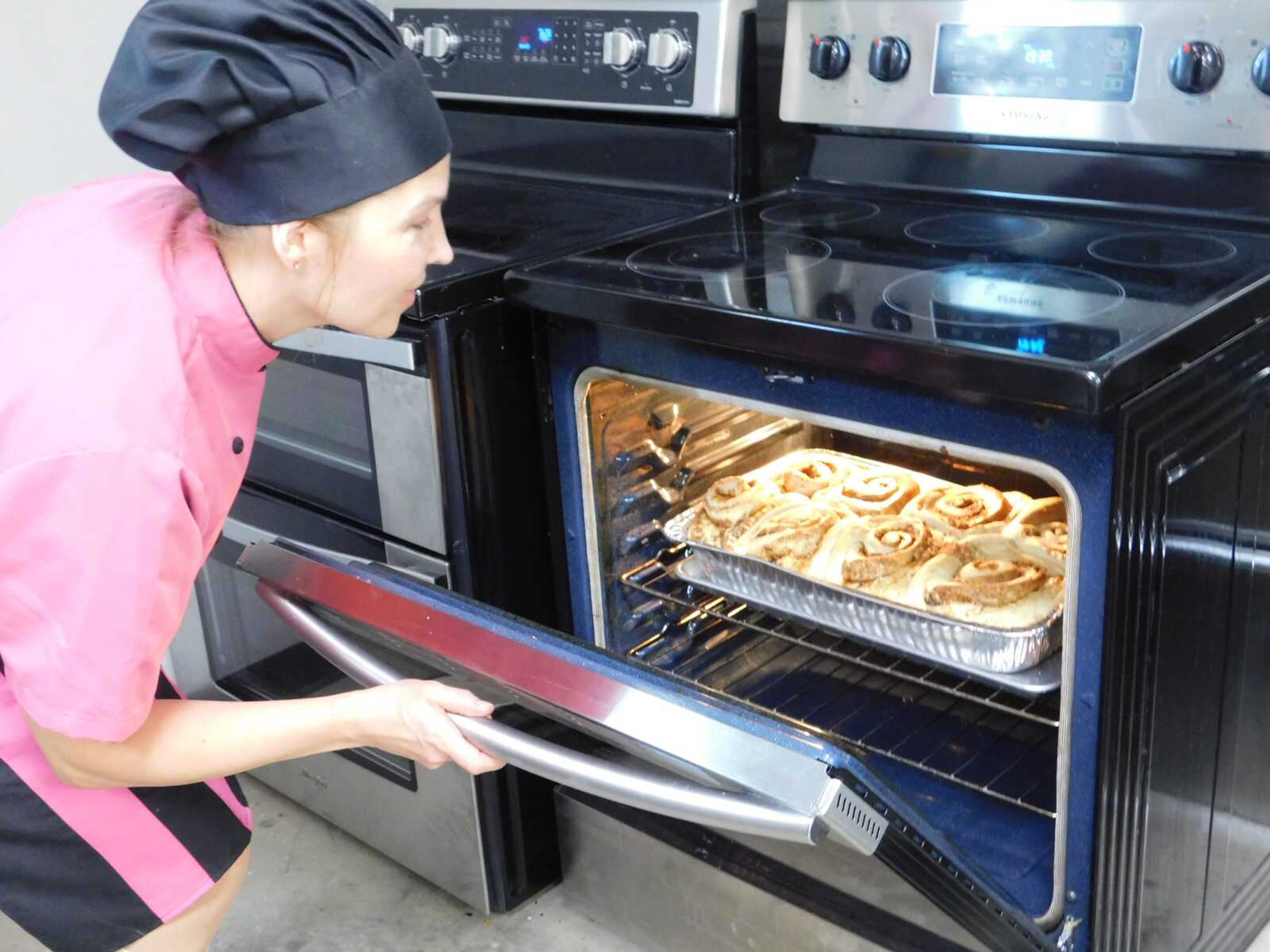 Marble Hill Cakes owner Valeriia Nagornykh checks on a batch of cinnamon rolls Thursday, Oct. 19, in Jackson. She said the rolls are one of her best-selling products alongside macarons.