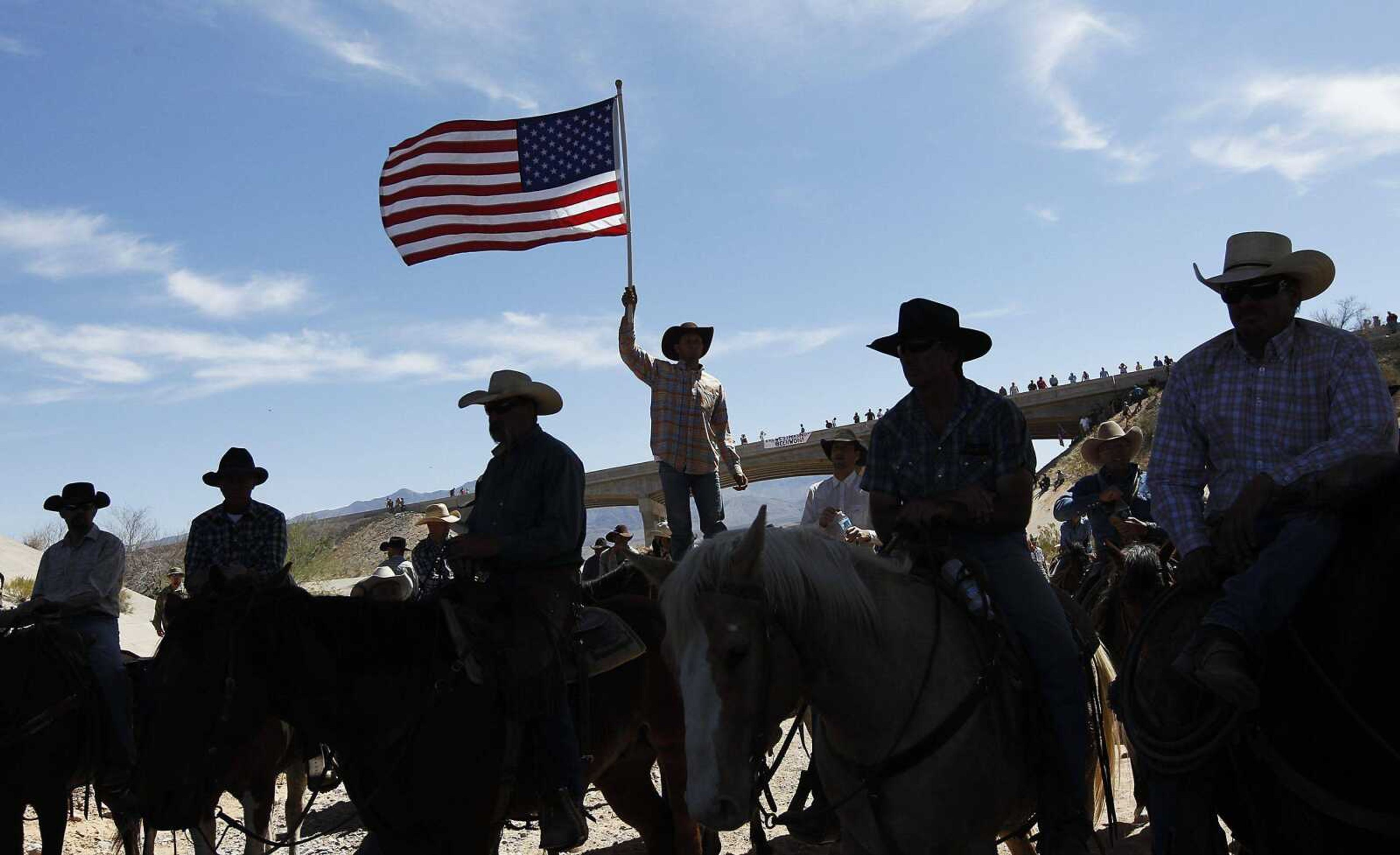 A supporter of the Bundy family flies the American flag after the Bureau of Land Management agreed Saturday to release the Bundys&#8217; cattle near Bunkerville, Nev. (Jason Bean ~ Las Vegas Review-Journal)