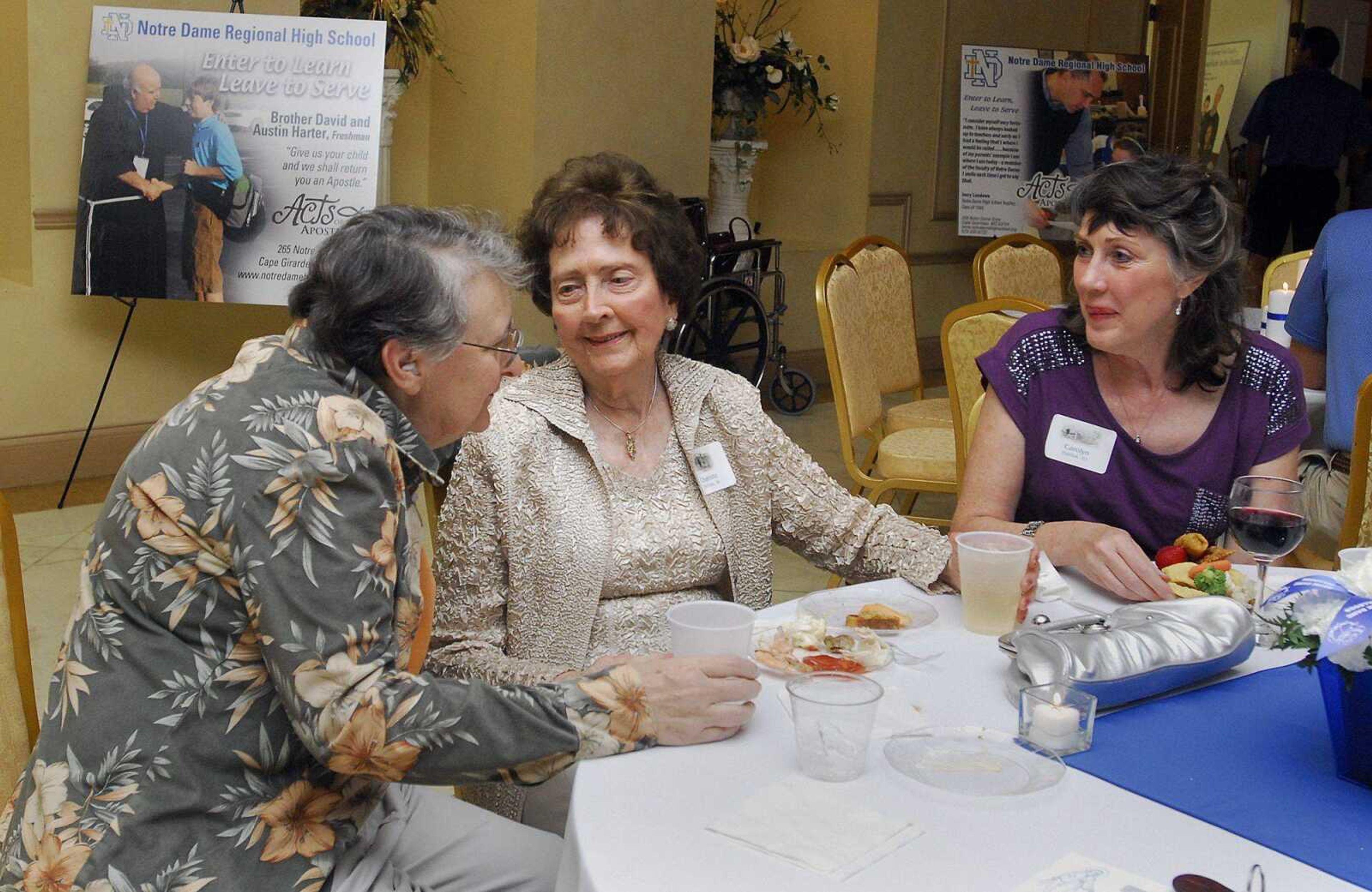 Charlene Urhahn, left, speaks with Charlotte McCrate and her daughter Carolyn Hajduk during Saturday's Notre Dame Regional High School's all-class reunion at The Venue in Cape Girardeau. All of McCrate's six children attended Notre Dame. More than 400 people attended the first of the school's all-class reunions, which included a Mass, appetizers and a dance. (Laura Simon)