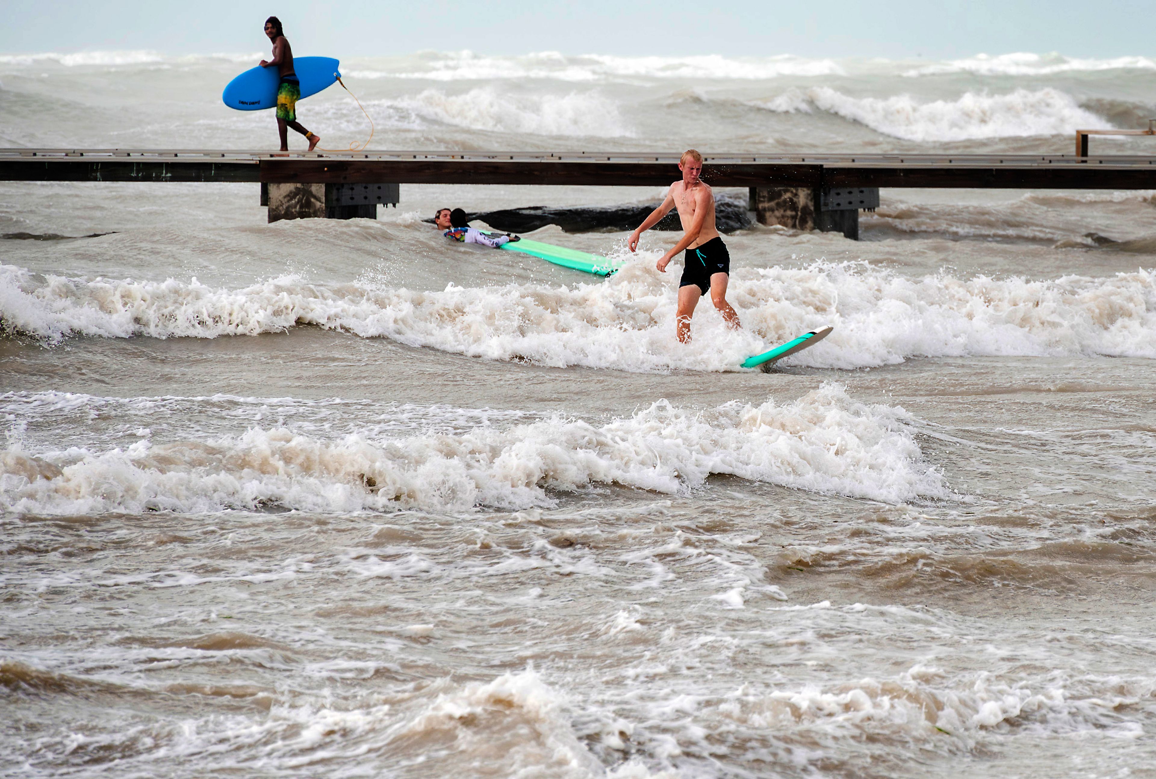 Surfers take advantage of heavy winds along Higgs Beach in Key West, Florida, on Thursday, Sept. 26, 2024. Despite passing the Florida Keys by hundreds of miles, sustained winds over 40 mph churned up the usually calm, nearshore waters. (Rob O'Neal/The Key West Citizen via AP)