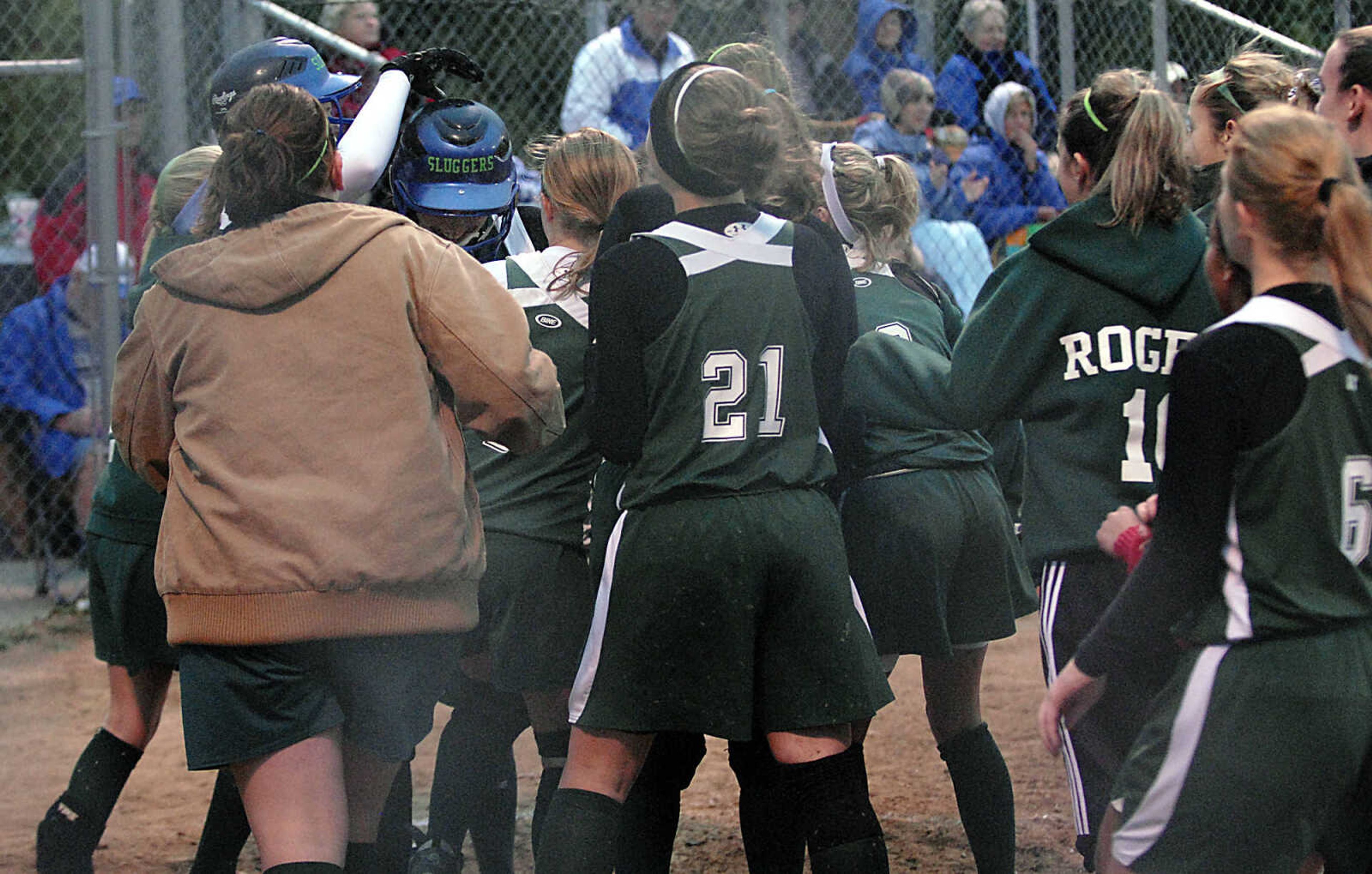 KIT DOYLE ~ kdoyle@semissourian.com
DeSoto players swarm around Dee Dee Peters following the sophomore's solo homer against Notre Dame Thursday, October 15, 2009, in Poplar Bluff.