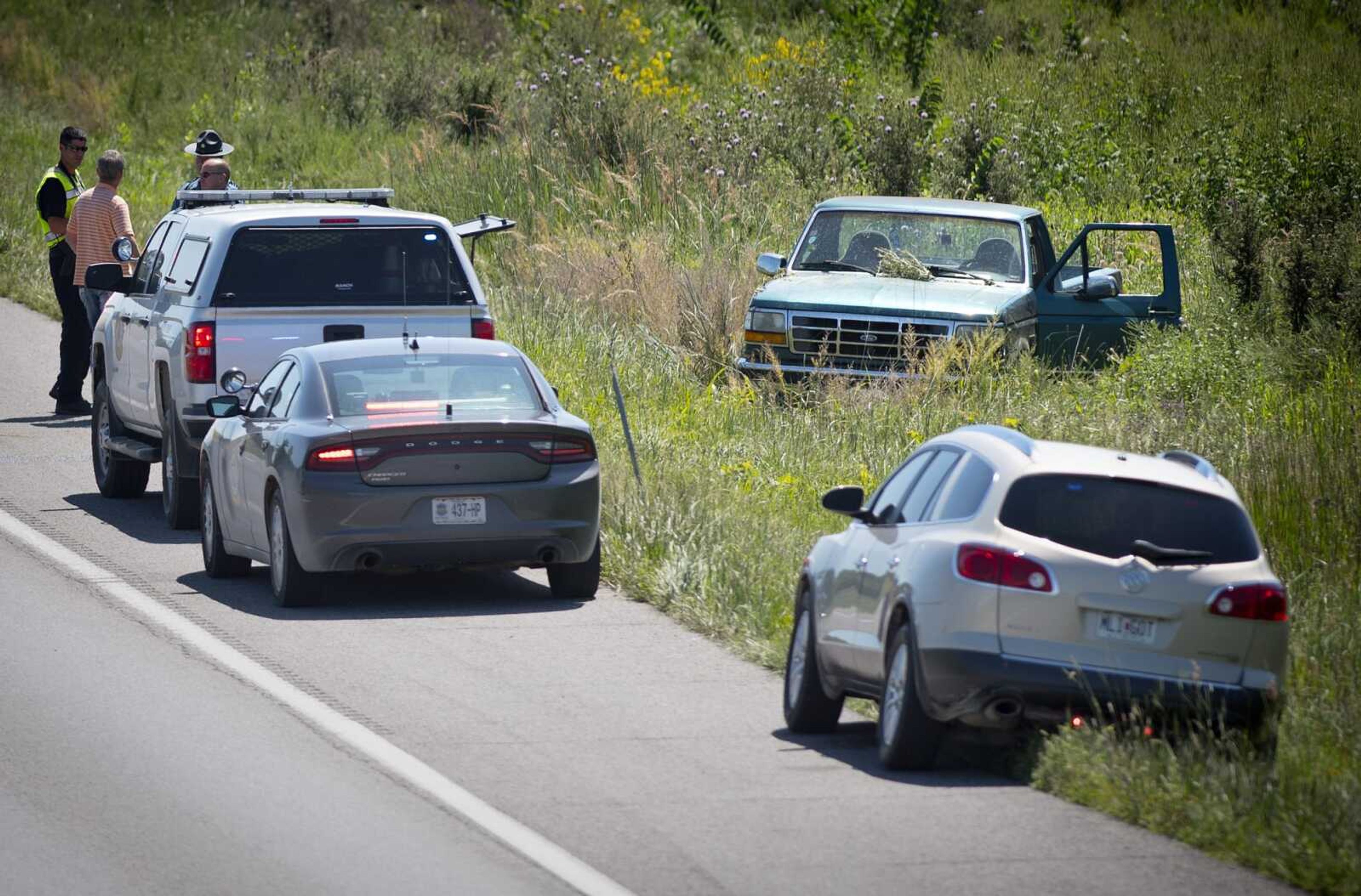 Emergency personnel investigate a vehicle involved in a collision Thursday after being driven north on the southbound lanes of Interstate 55 before the driver abandoned the vehicle and fled from police on foot into the woods behind Cape County Cowboy Church, east of Oak Ridge.