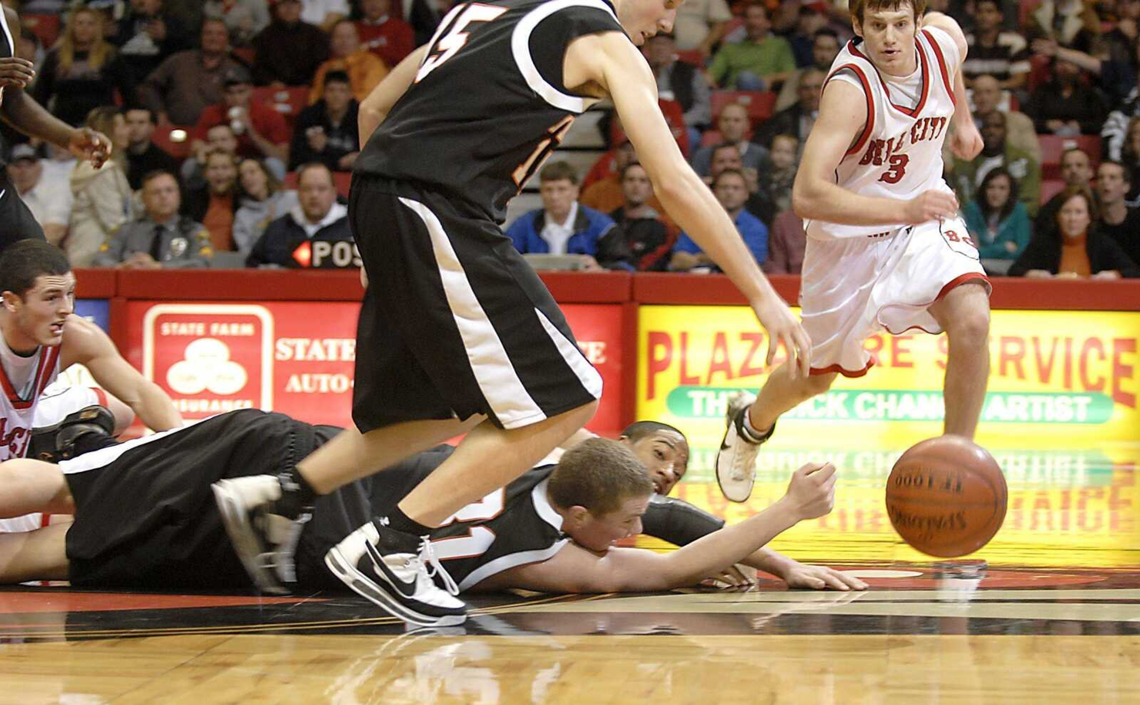 Players sprawled across the Show Me Center court for a loose ball in the final seconds of the Bell City's loss to Central Thursday, December 27, 2007, in the Southeast Missourian Christmas Tournament.  Central's Anthony Watts, center, picked up the ball in front of Bell City's Nick Niemczyk.  Wattts was fouled and then hit two free throws to win the game by four points. (Kit Doyle)