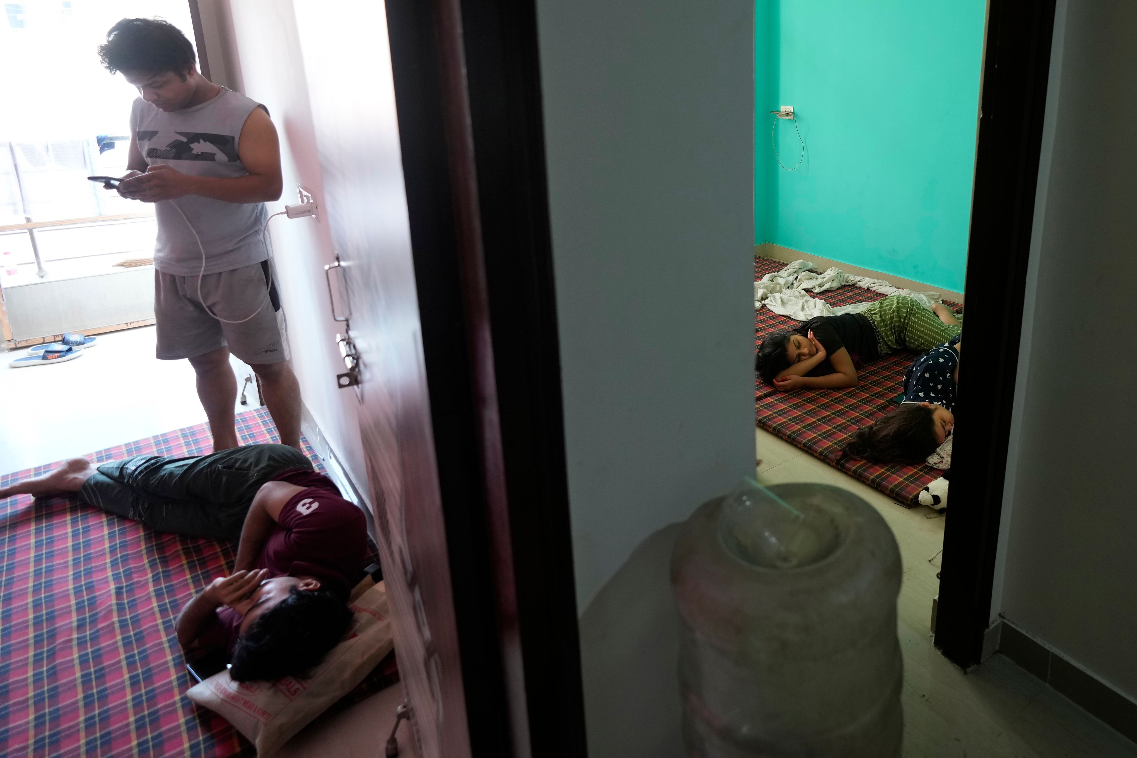 Actors performing in Ramleela, a dramatic folk re-enactment of the life of Hindu god Rama according to the ancient Hindu epic Ramayana, rest at their rented accommodation in New Delhi, India, Wednesday, Oct. 9, 2024. (AP Photo/Manish Swarup)