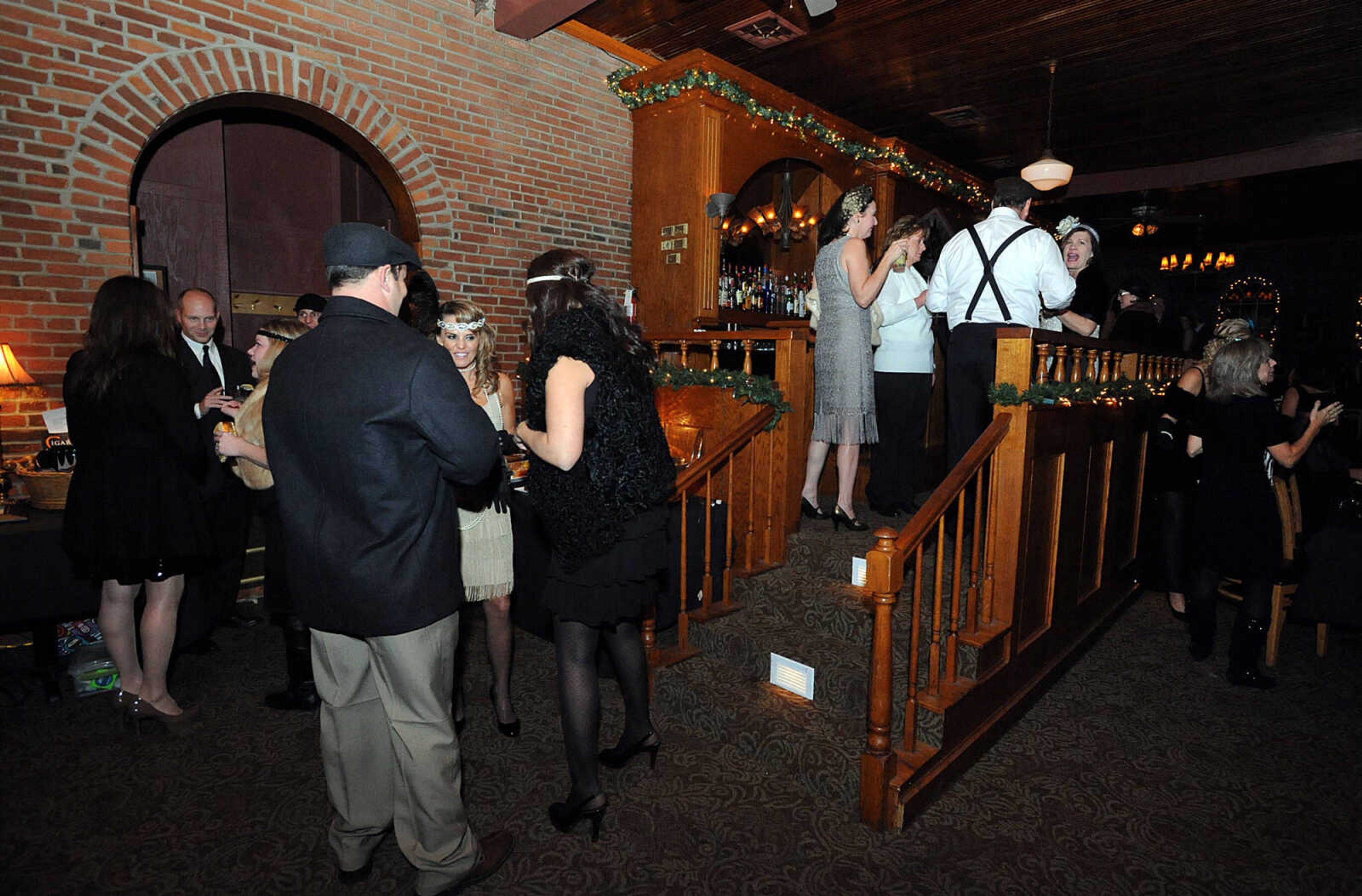 LAURA SIMON ~ lsimon@semissourian.com
People in 1920's attire mingle Friday, Nov. 30, 2012 during CASA's Speakeasy Soiree at Port Cape's Yacht Club in Cape Girardeau.