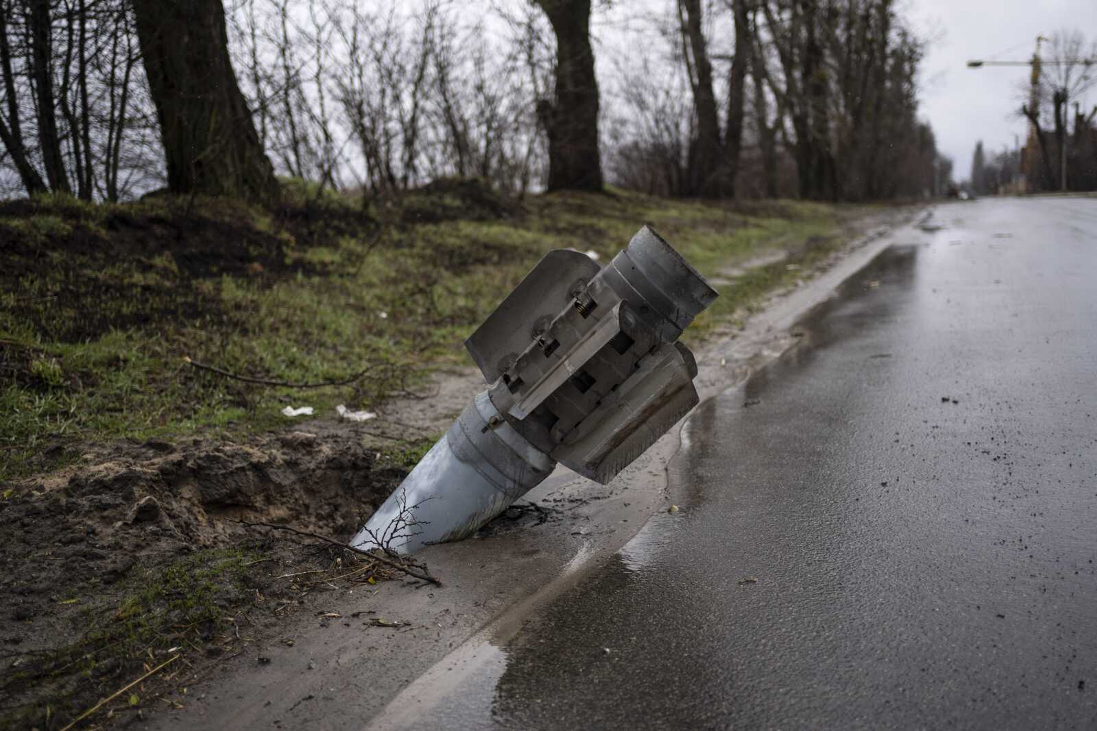 A rocket is buried in the ground Sunday in Bucha, Ukraine.