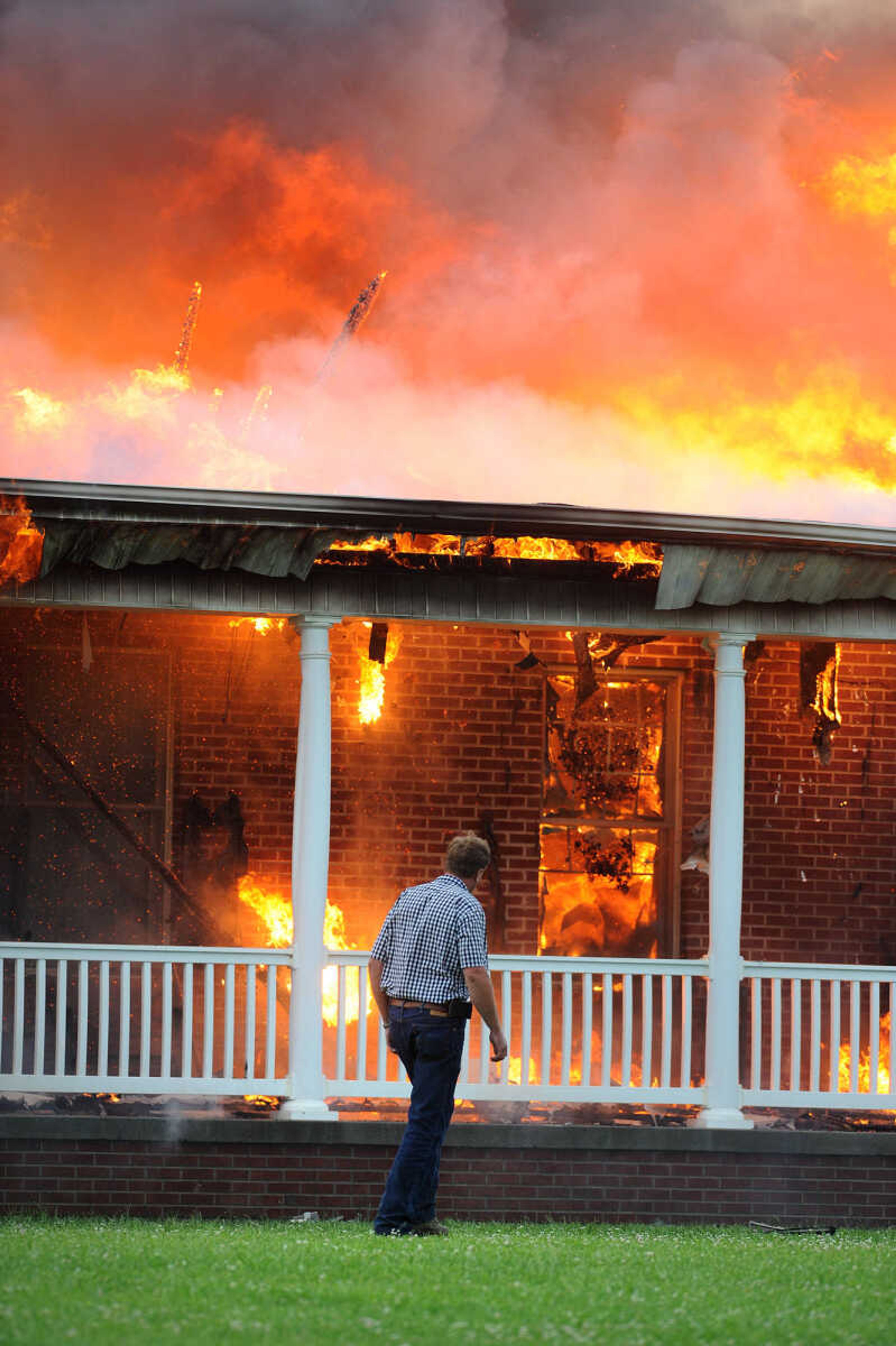 LAURA SIMON ~ lsimon@semissourian.com

David Landewee circles the perimeter of his house as firefighters from Delta, Scott City, Chaffee and New Hamburg/Benton/Commerce battle the fire engulfing his house off County Road 204 in Scott County Wednesday afternoon, July 23, 2014.