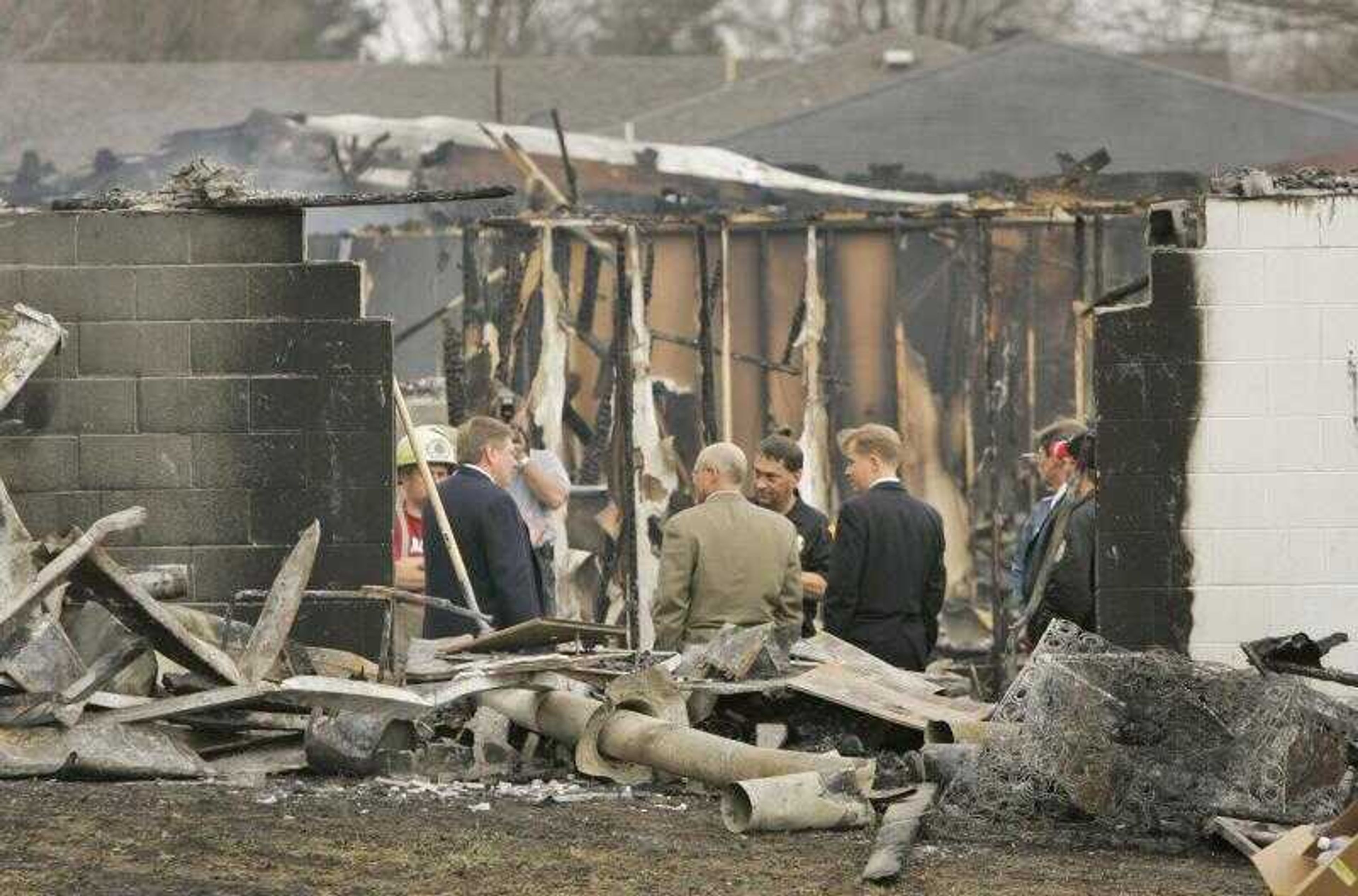 A group of officials, including Missouri Gov. Matt Blunt, center right, visited the scene of a group home fire Monday in Anderson, Mo. Flames swept through a southwest Missouri group home for the elderly and mentally ill Monday, killing 10 people and injuring two dozen more in one of the state's deadliest fire disasters. (Orlin Wagner ~ Associated Press)