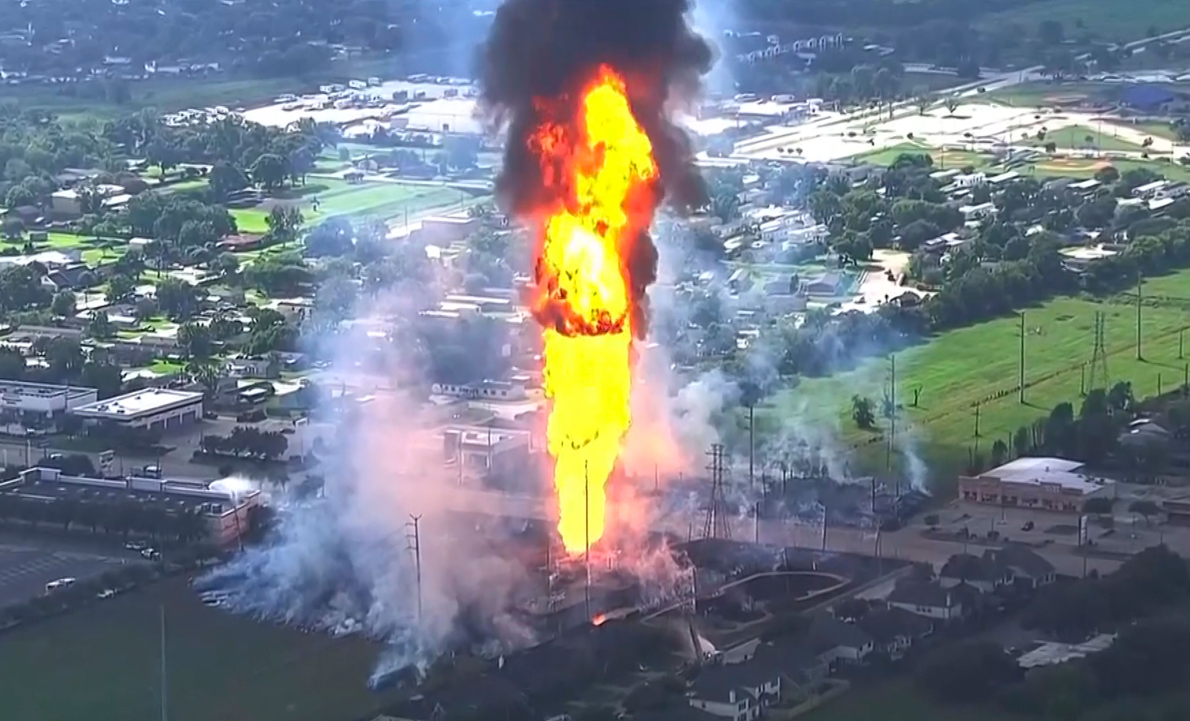 A pipeline fire in La Porte, Texas, sparks grass fires and burns power poles on Monday, Sept. 16, 2024, forcing people in the surrounding neighborhood to evacuate. (KTRK via AP)