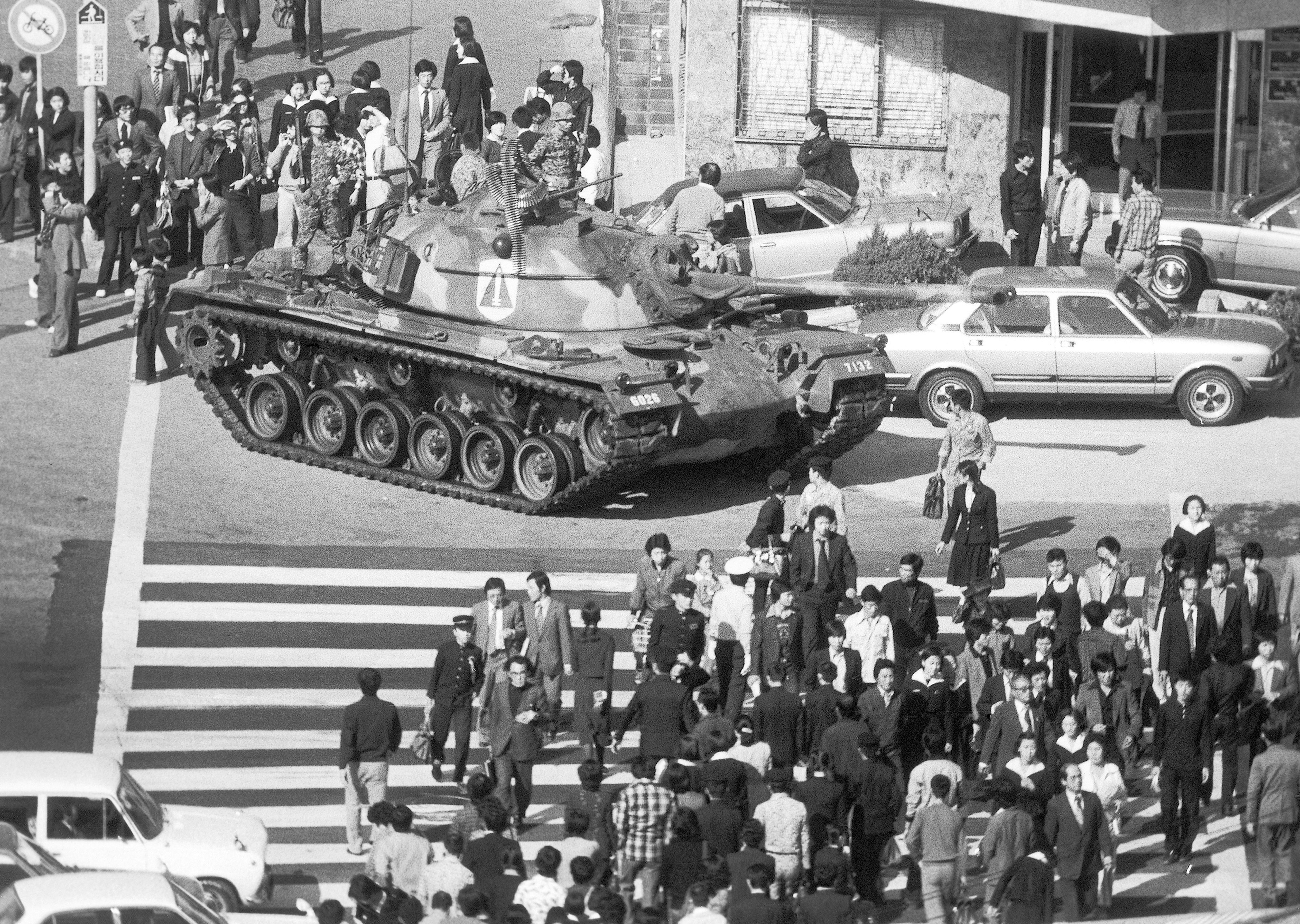 FILE- Seoul citizens walk beside an army tank on Saturday, Oct. 27, 1979, after martial law was declared following the death of President Park Chung-Hee. (AP Photo/Kim Chon-Kil, File)