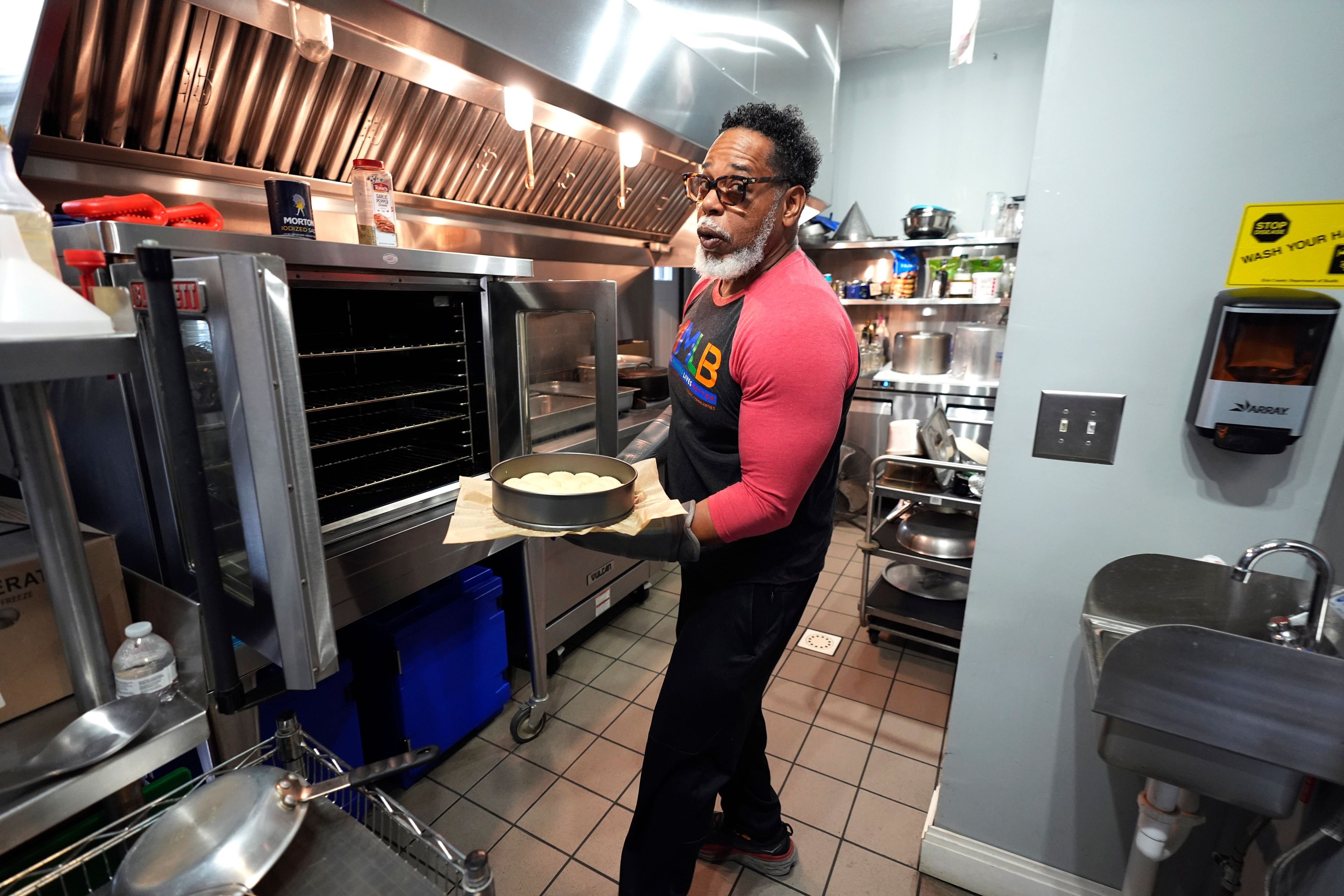 Small business owner Michael Hooks works in the kitchen of his catering business in Erie, Pa. Friday, Nov. 1, 2024. (AP Photo/Gene J. Puskar)