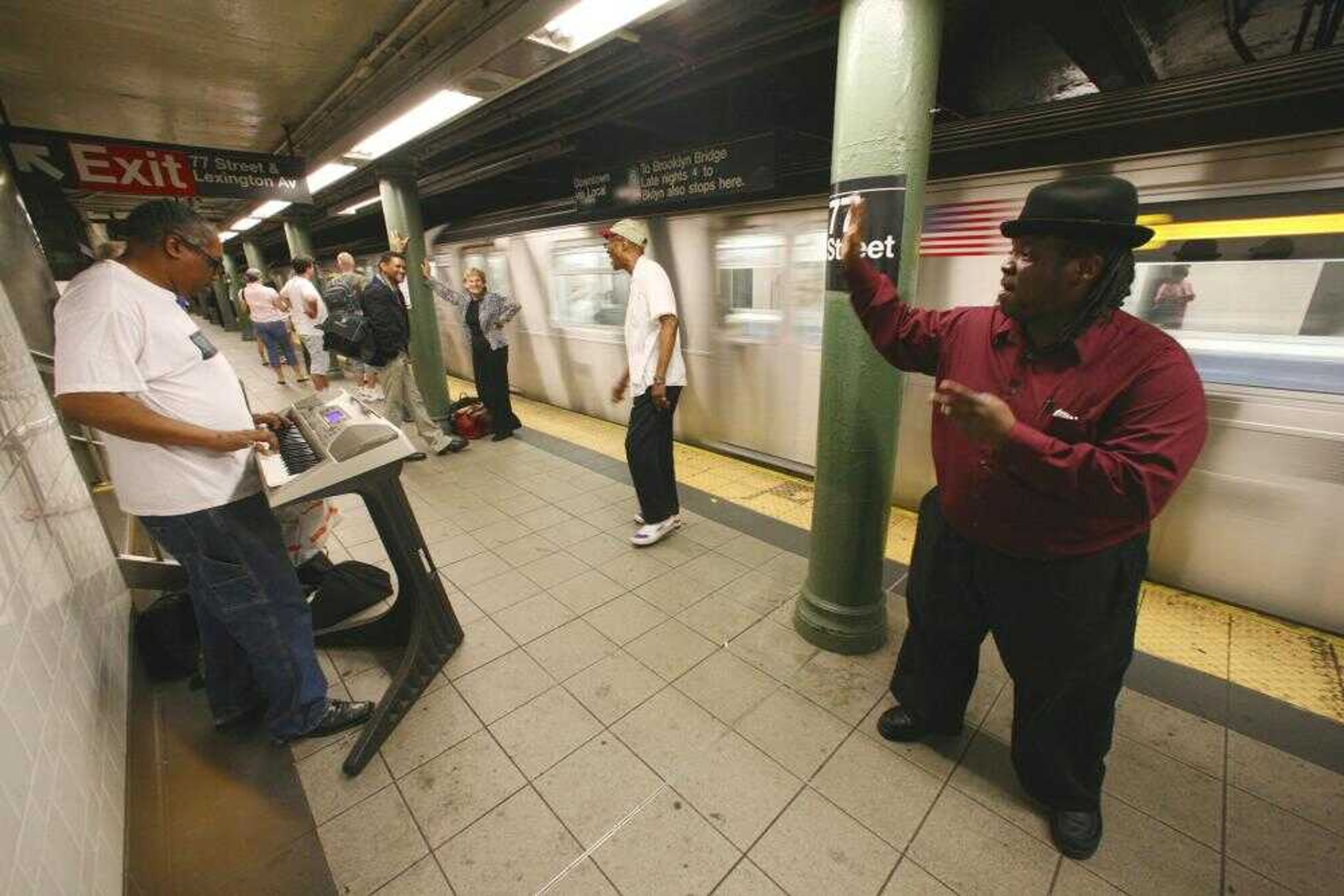 Alphonso McGruder, far left, Ray "Sugar Ray" Sanders, second from right, and Michael Lee Anthony, far right, performed oldies songs Tuesday as a train arrived in the 77th Street subway station in New York. The city's noise code was revised amid strong debate and will take effect July 1 after noise complaints increased steadily the past few years. Some commuters said they considered the singers "good noise." (Bebeto Matthews ~ Associated Press)