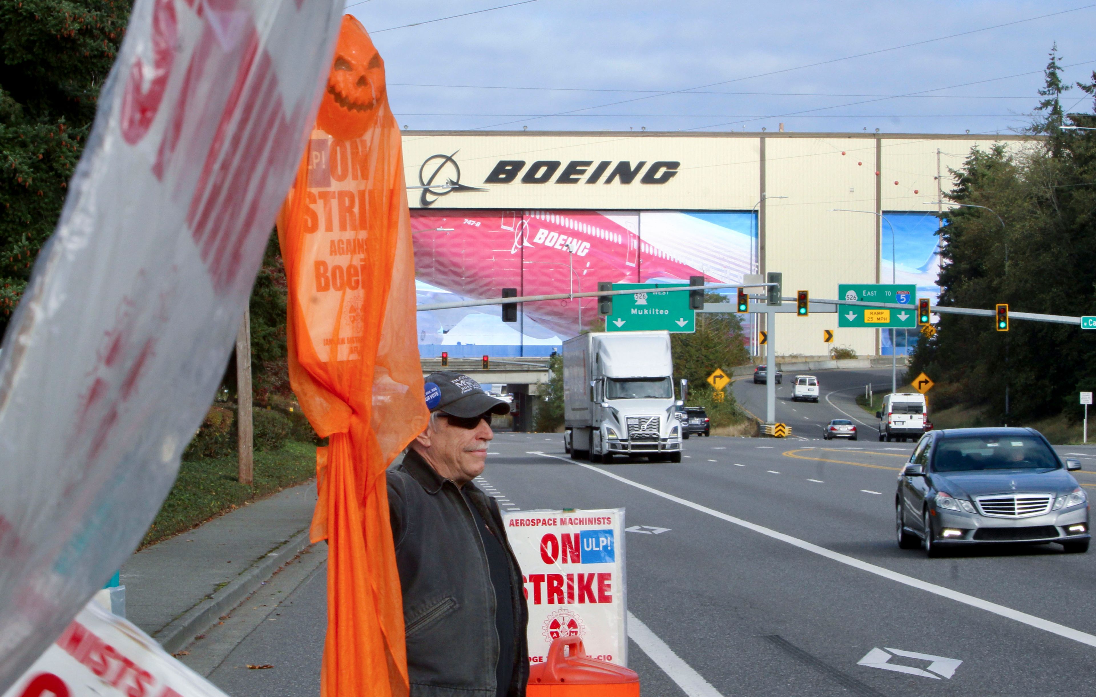 Union machinist Terry Muriekes waves a Halloween-decorated strike sign by Boeing's Everett, Wash., factory on Tuesday, Oct. 22, 2024. (AP Photo/Manuel Valdes)