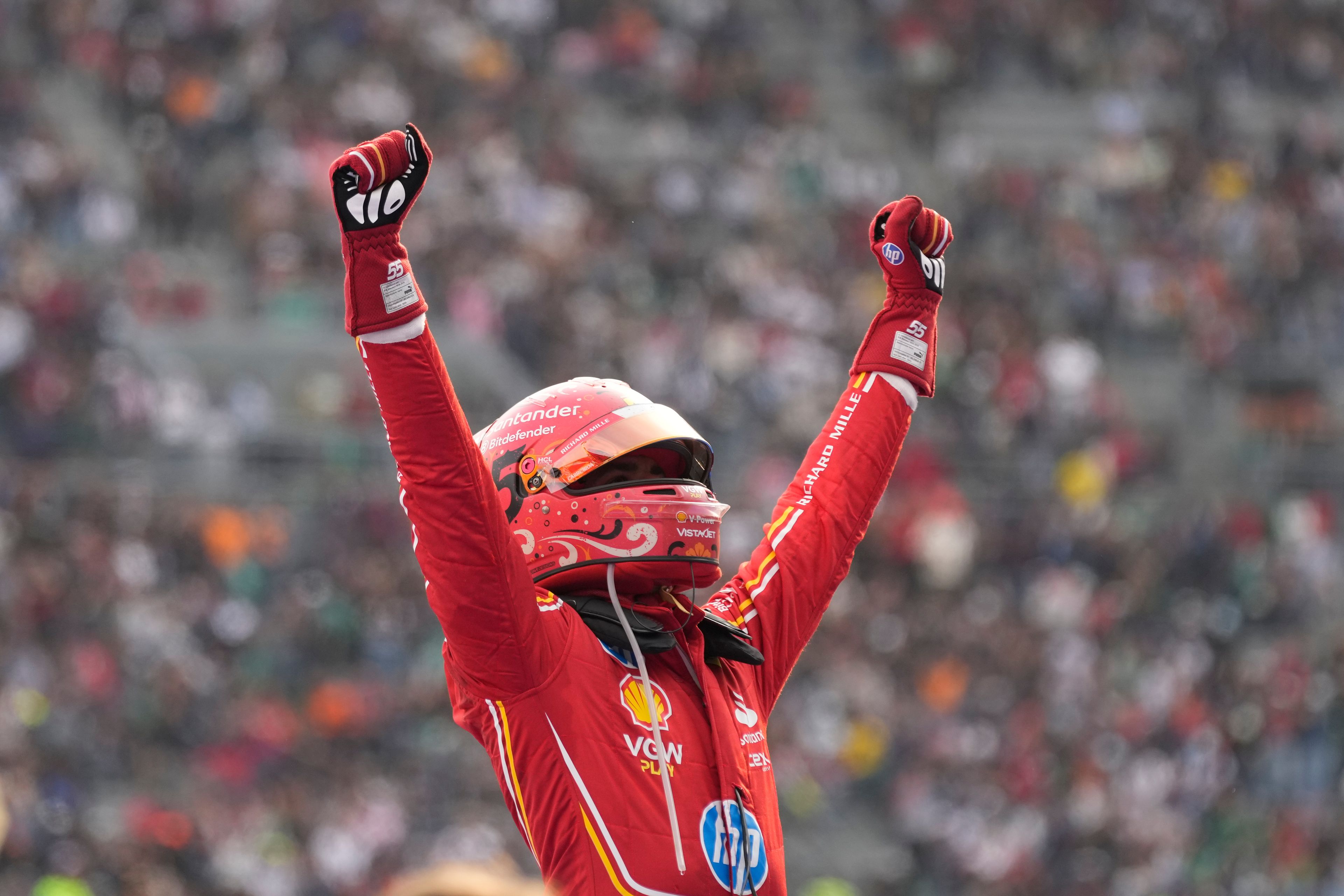 Ferrari driver Carlos Sainz of Spain celebrates after winning the Formula One Mexico Grand Prix auto race at the Hermanos Rodriguez racetrack in Mexico City, Sunday, Oct. 27, 2024. (AP Photo/Moises Castillo)