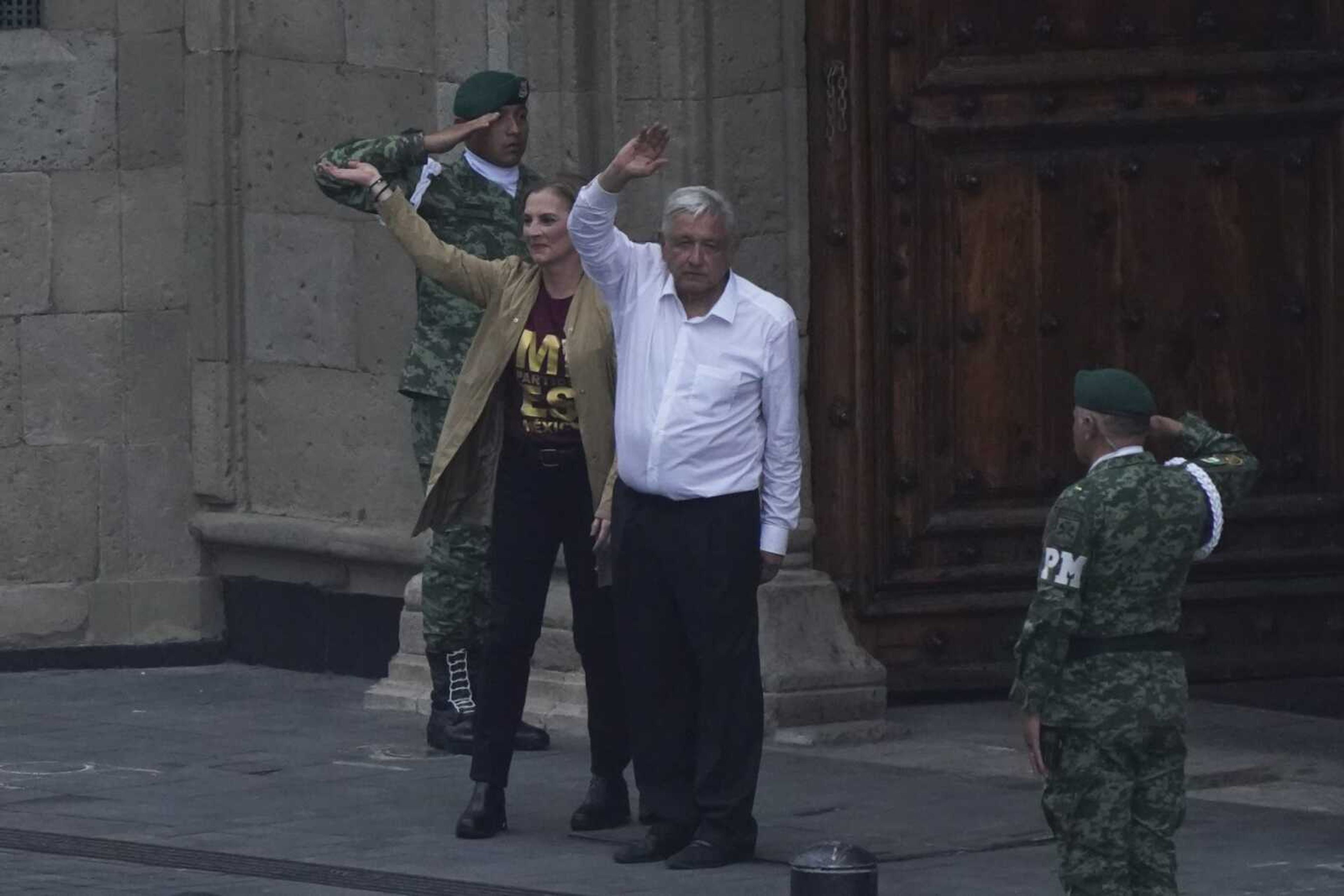 Mexican President Andres Manuel Lopez Obrador and his wife, Beatriz Gutierrez, say farewell after a march to the capital's main square, the Zocalo, where thousands met to show their support for his government Sunday, Nov. 27, in Mexico City.