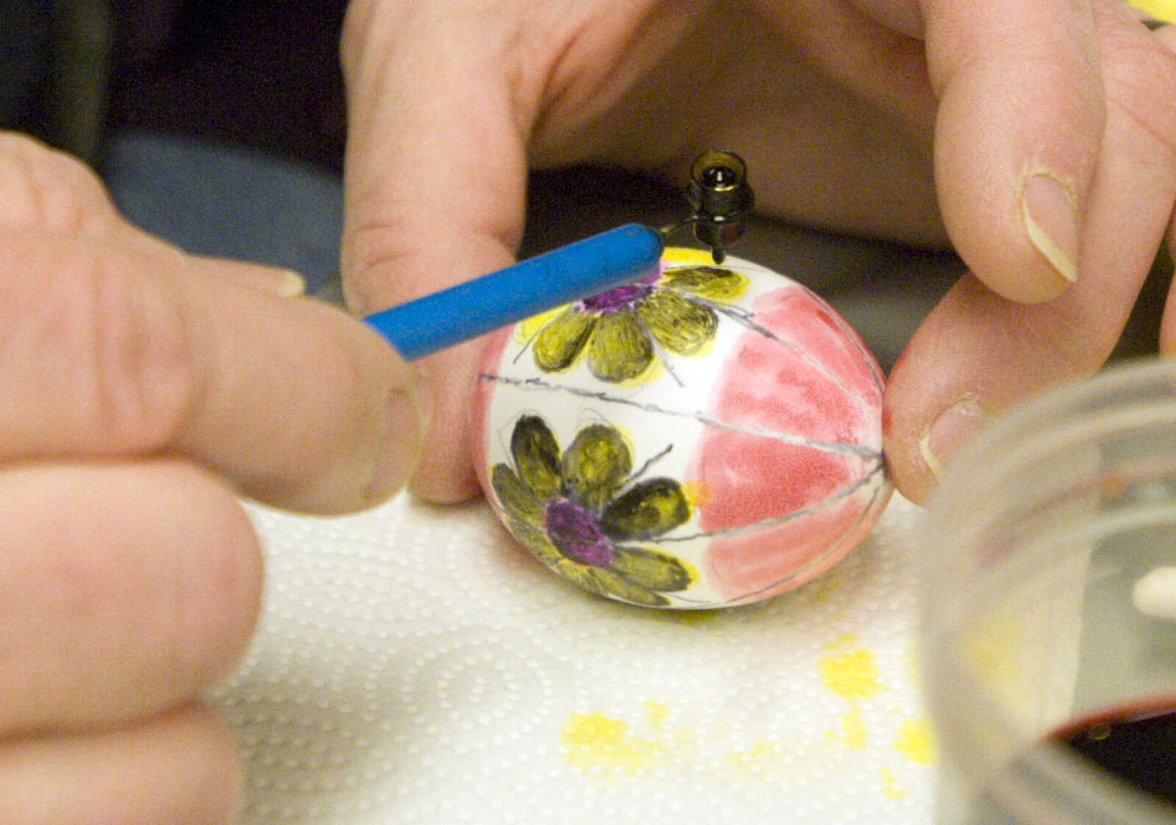 LAURA SIMON ~ lsimon@semissourian.com
Dodie Eisenhauer applies a layer of beeswax over the dye on her egg Tuesday, March 19, 2013 during the Wonderful World of Pysanky workshop at Southeast Missouri State University's River Campus. In Pysanky, Ukrainian egg art, each color and design is symbolic. The flower is symbolic of love and wisdom, and the yellow is symbolic of recognition and reward. Instructor Barb Duncan has teaching people of all ages the art of Pysanky for 16 years.