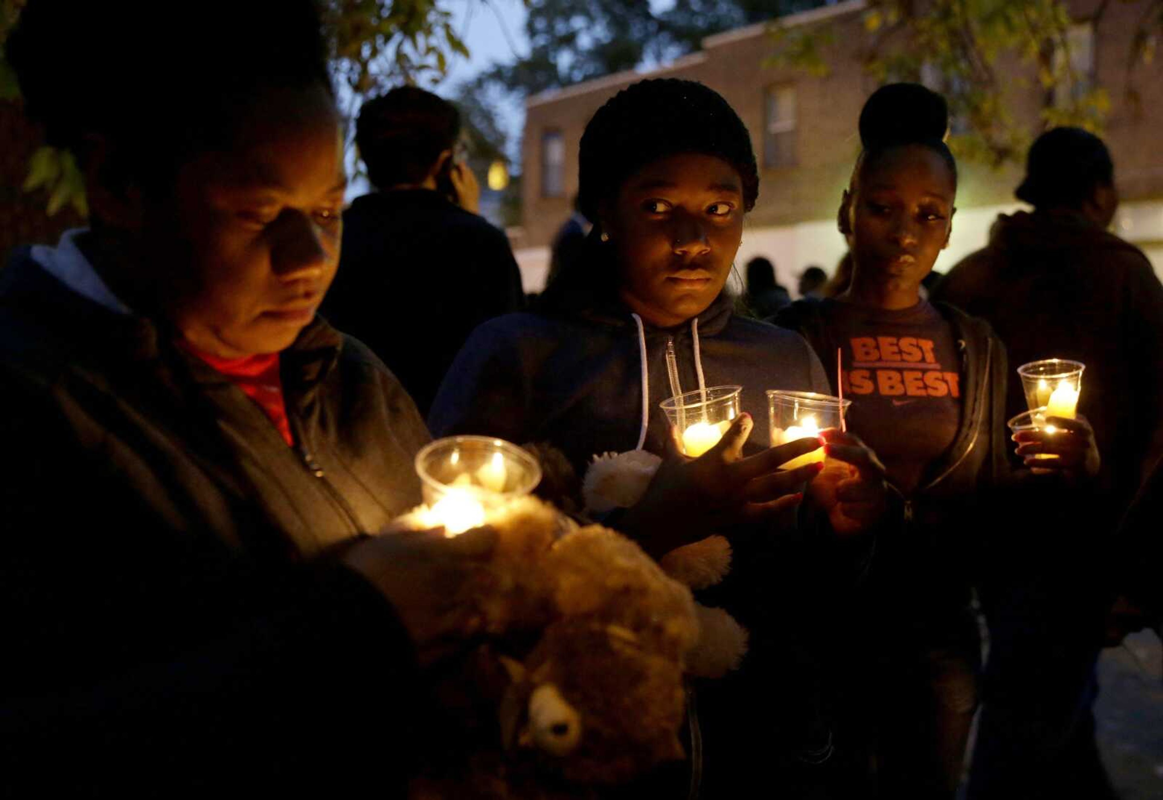 People gather for a candlelight vigil Oct. 9 to remember Vonderrit Myers Jr. in St. Louis. A lawyer for the family of the black 18-year-old shot and killed in October by an off-duty, white St. Louis police officer said Tuesday he plans to file a wrongful-death lawsuit, after a prosecutor said the officer would not face criminal charges. (Associated Press)