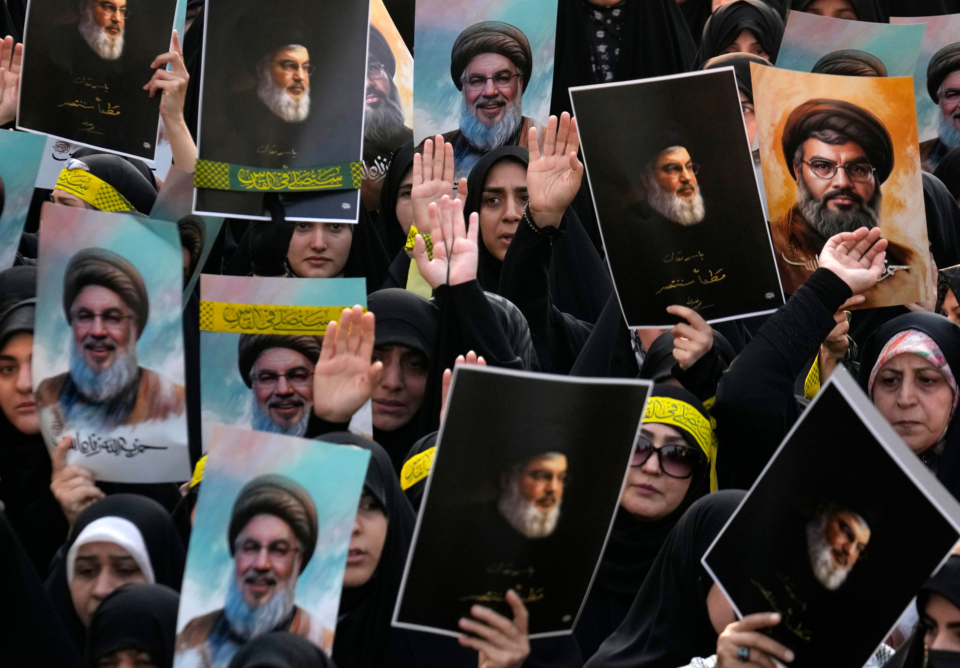 Mourners attend a rally commemorating slain Hezbollah leader Hassan Nasrallah and hold up his portraits, at Enqelab-e-Eslami (Islamic Revolution) St. in downtown Tehran, Iran, Monday, Sept. 30, 2024. (AP Photo/Vahid Salemi)