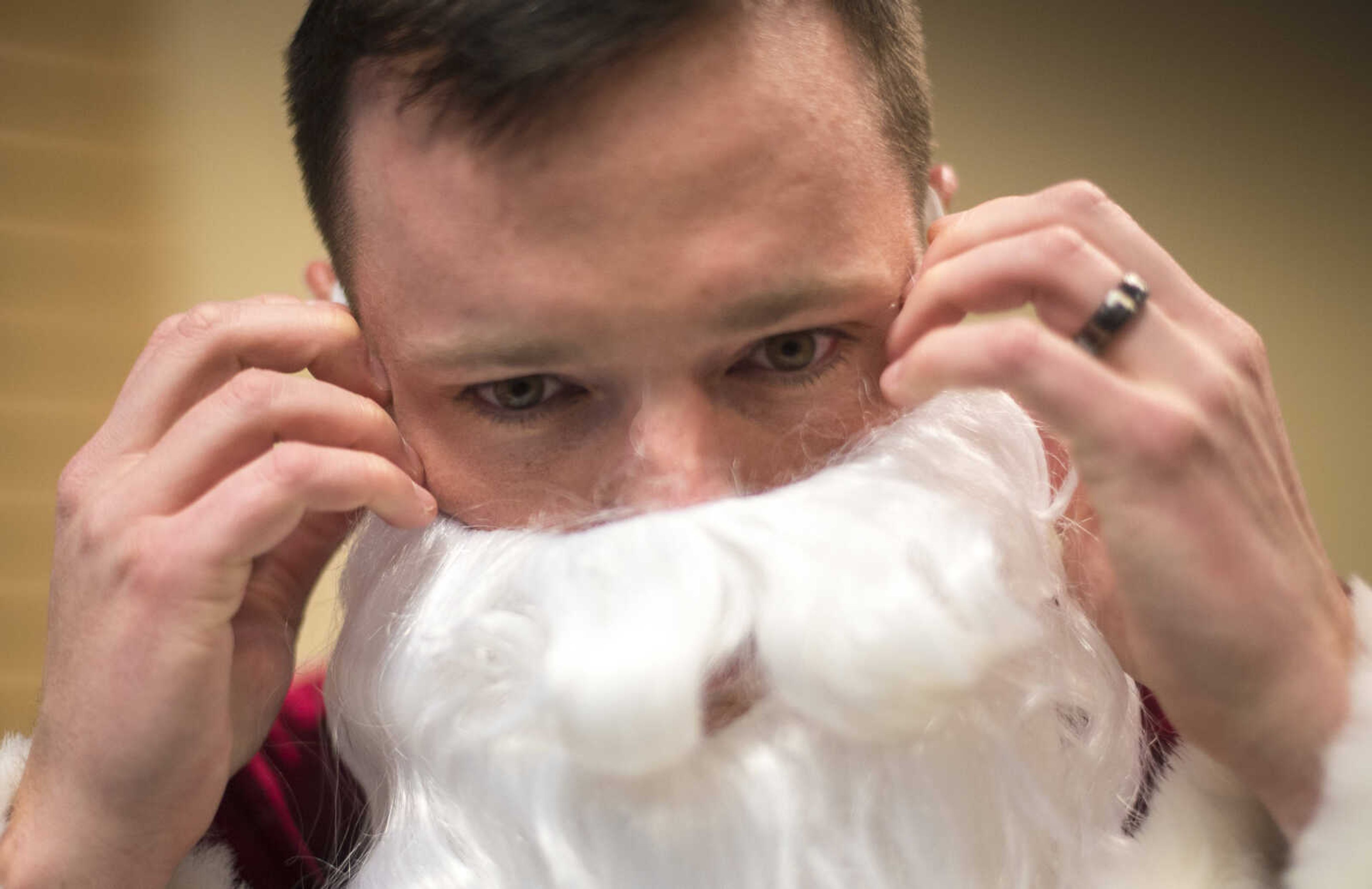 Clayton Camp puts on his Santa beard during the Jaycee Toybox delivery on Thursday, Dec. 21, 2017, in Cape Girardeau.