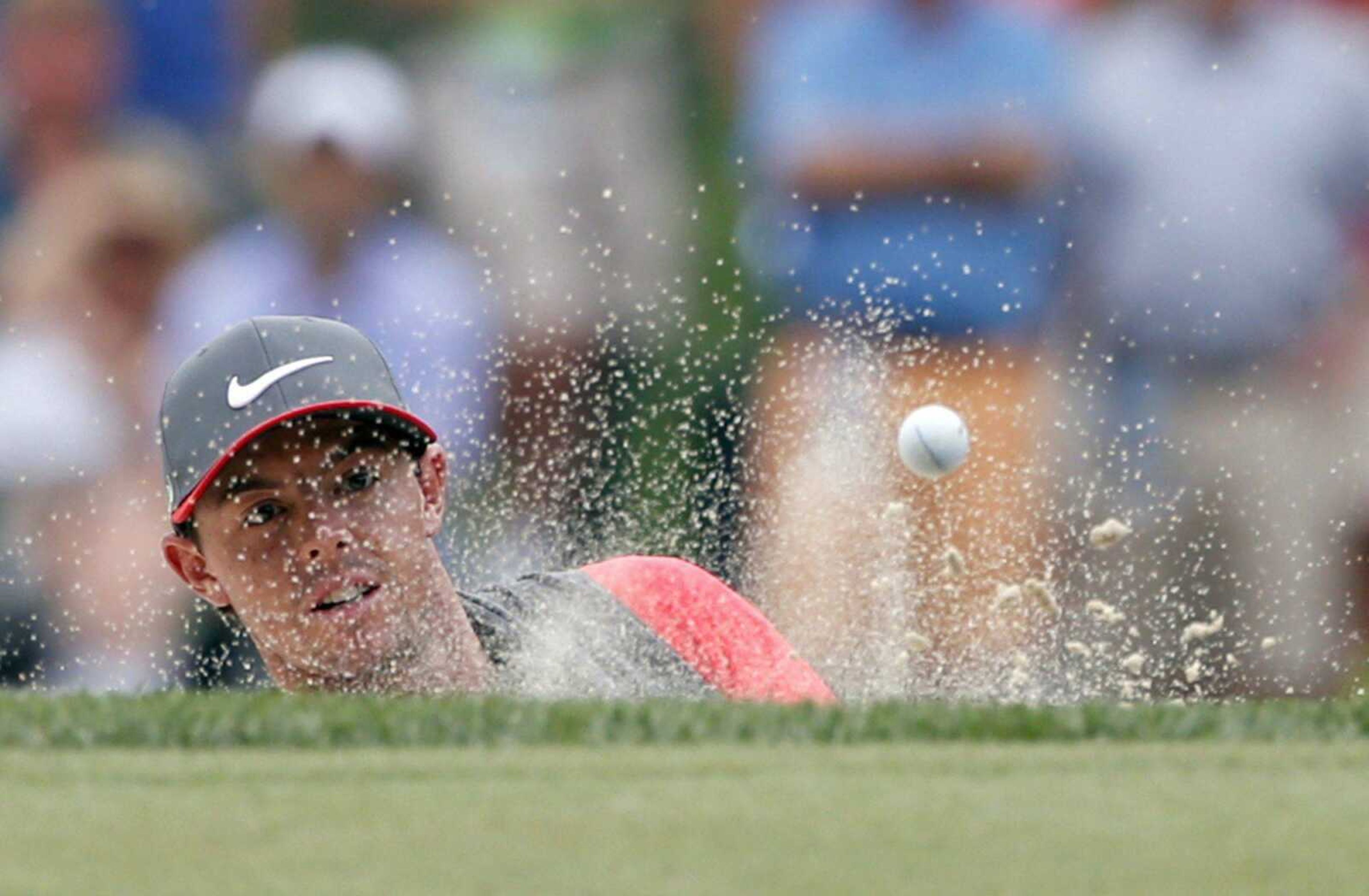 Rory McIlroy, of Northern Ireland, watches his shot out of the bunker on the sixth hole during the first round of the PGA Championship golf tournament Thursday at Valhalla Golf Club in Louisville, Ky. (Mike Groll ~ Associated Press)