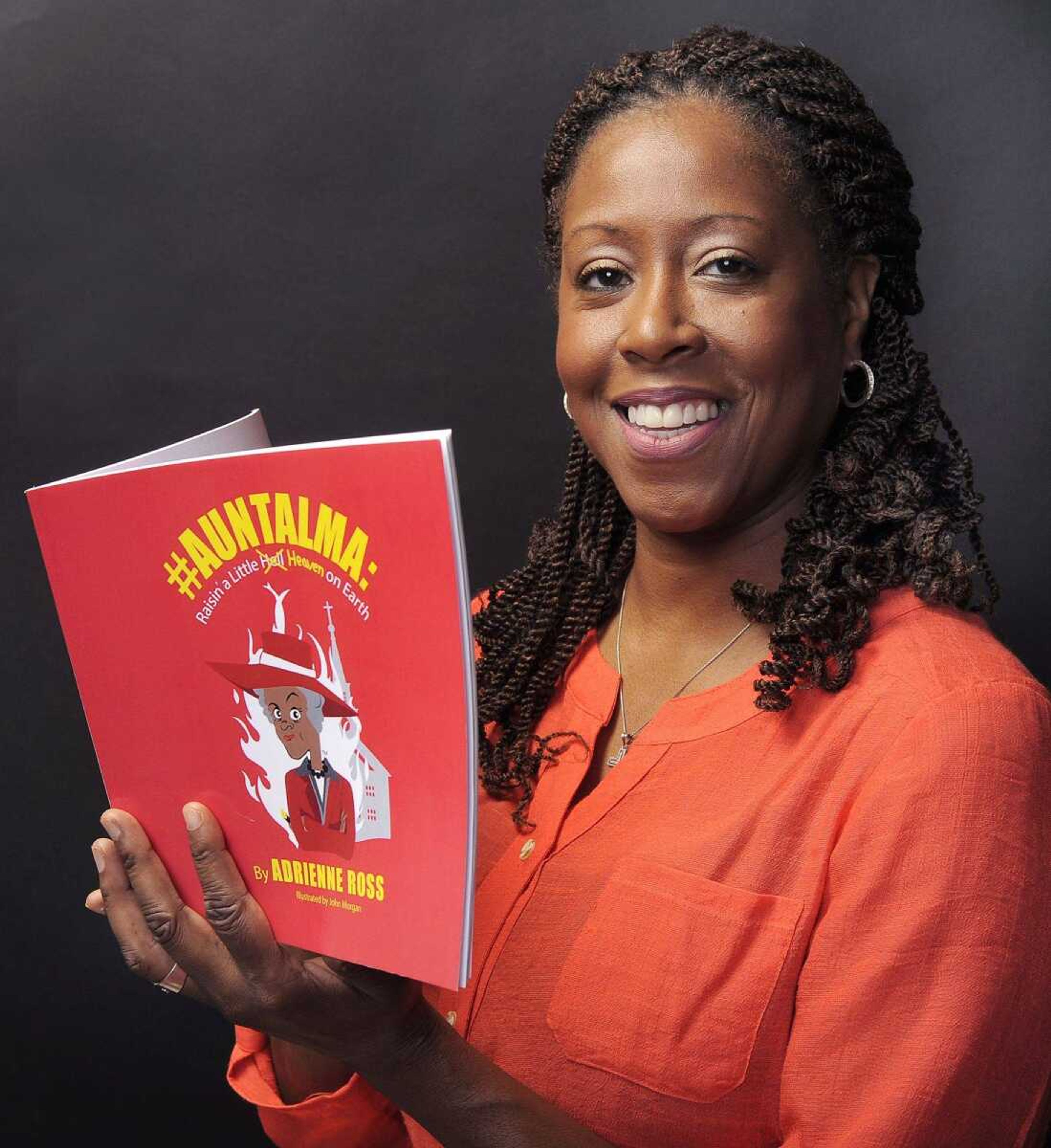 Adrienne Ross poses for a photo with her new book, "#AuntAlma: Raisin' a Little Heaven on Earth," on Wednesday, July 6, 2016 in Cape Girardeau.