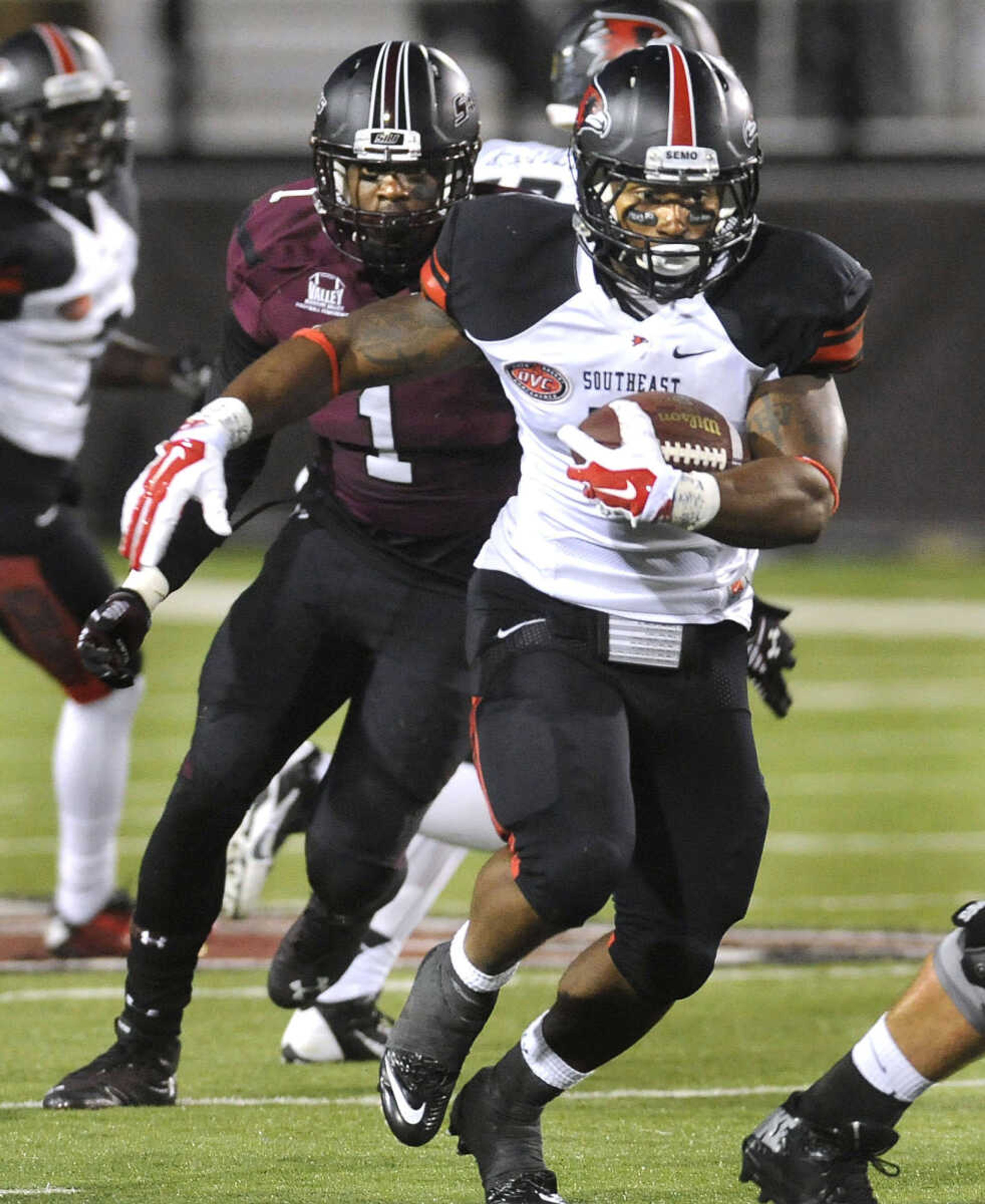 Southeast Missouri State running back Lennies McFerren carries away from Southern Illinois' Israel Lamprakes during the second quarter Saturday, Sept. 13, 2014 in Carbondale, Ill. (Fred Lynch)