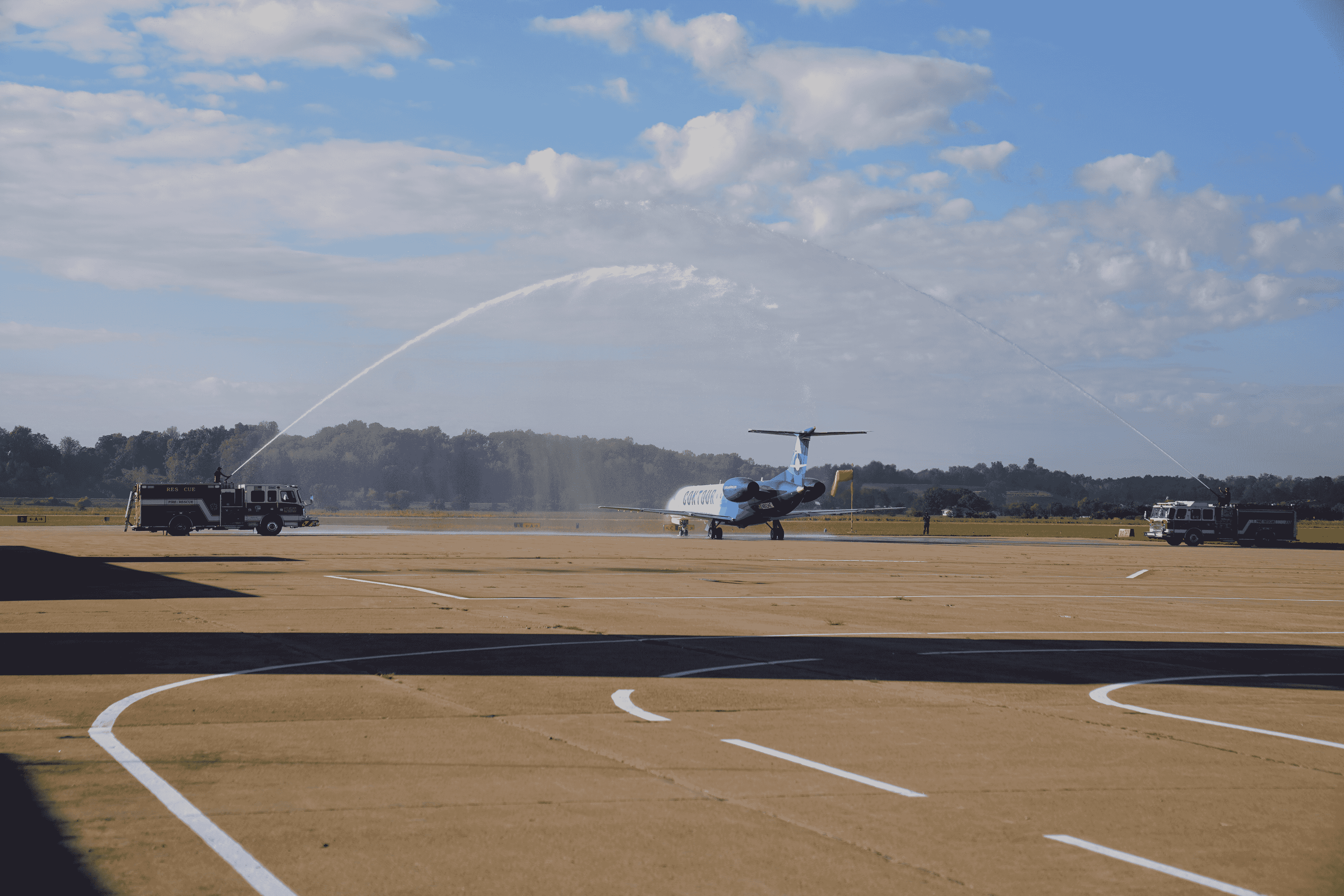 Cape Girardeau Fire Department shoots a water canon arch over the jet as it departs on its inaugural flight to Chicago. 