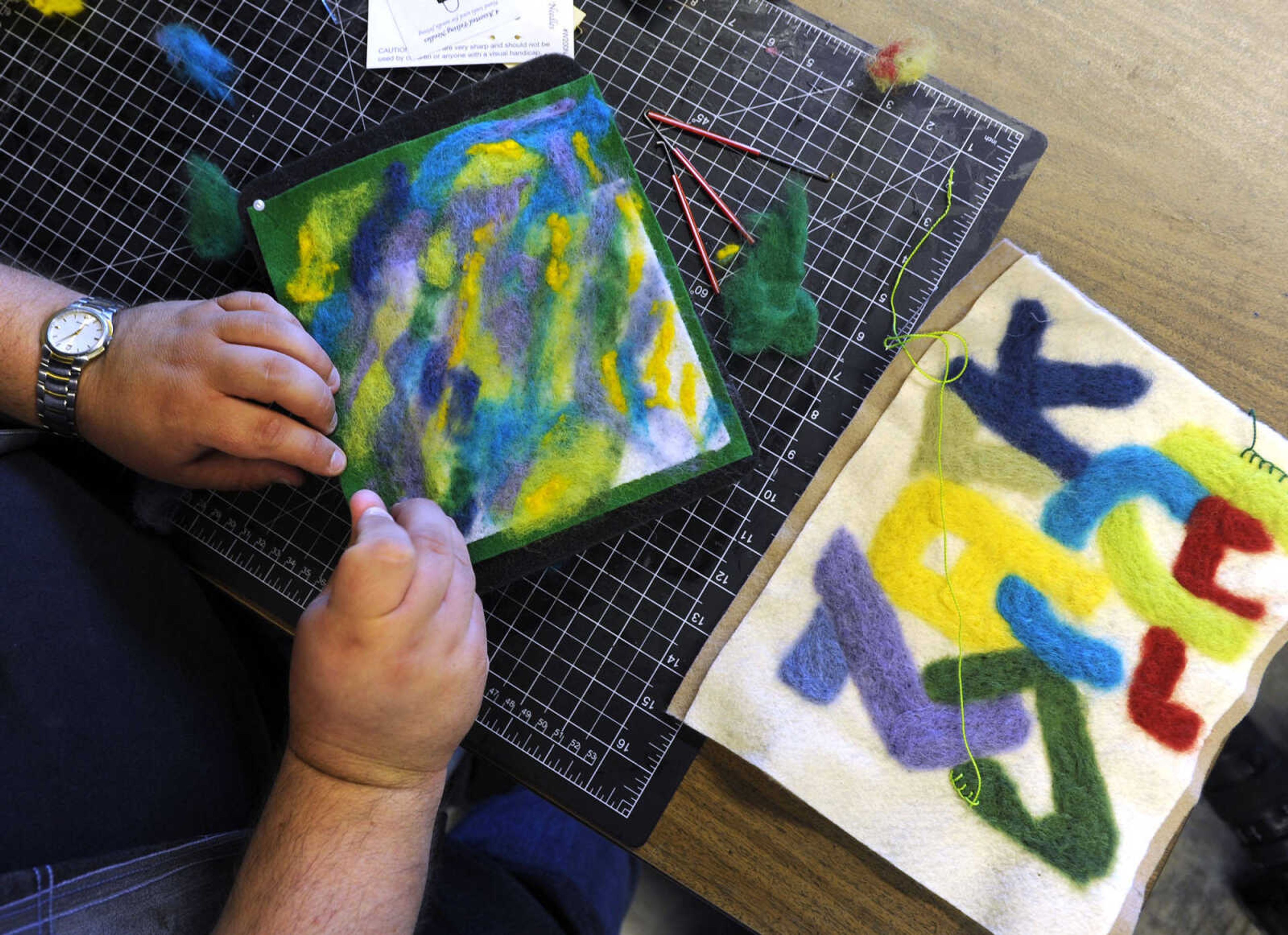 Shawn Guiling works on needle felting Saturday, June 21, 2014 at the River Campus Summer Arts Festival in Cape Girardeau