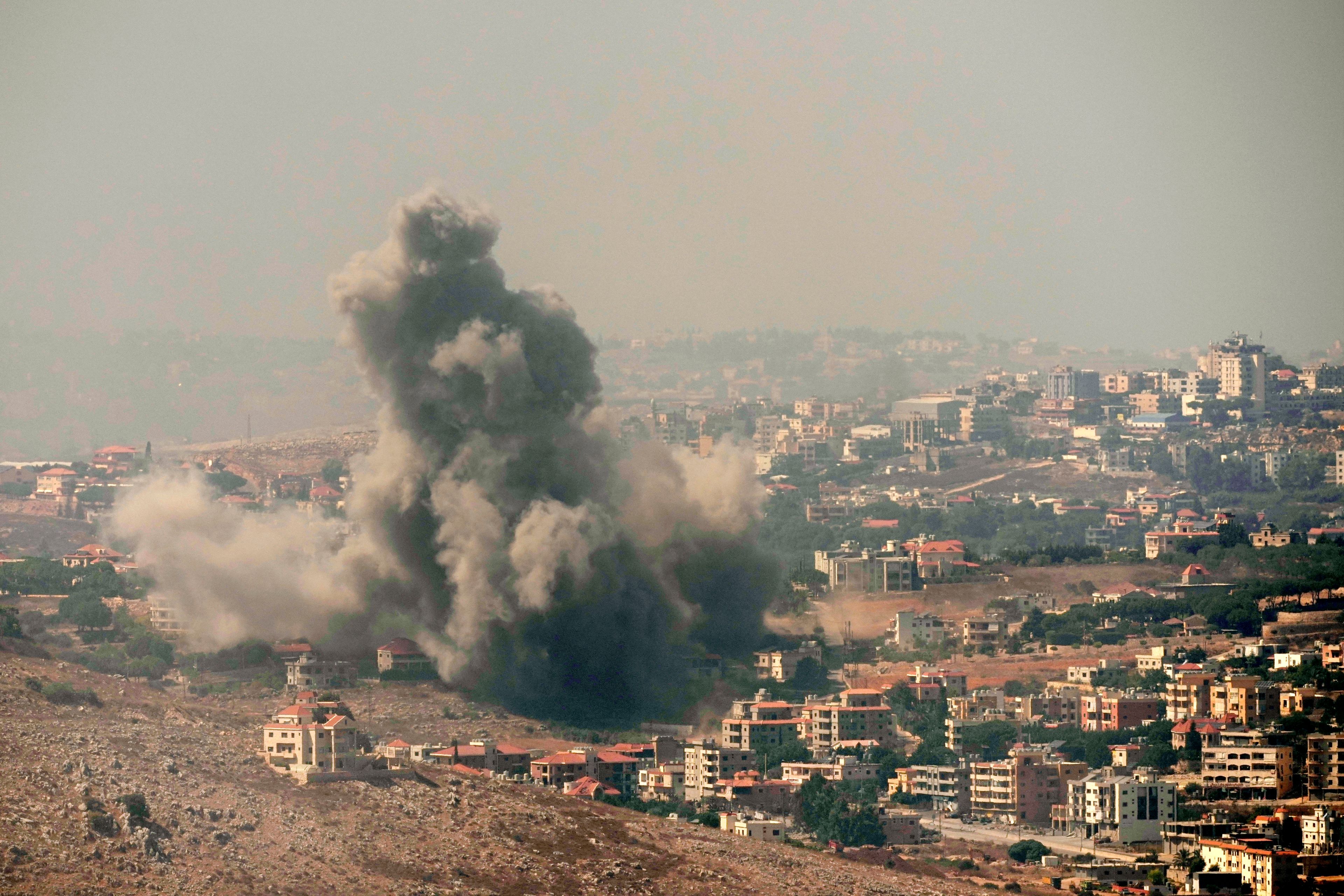 Smoke rises from Israeli airstrikes in the southern village of Kfar Rouman, seen from Marjayoun, south Lebanon, Wednesday, Sept. 25, 2024. (AP Photo/Hussein Malla)