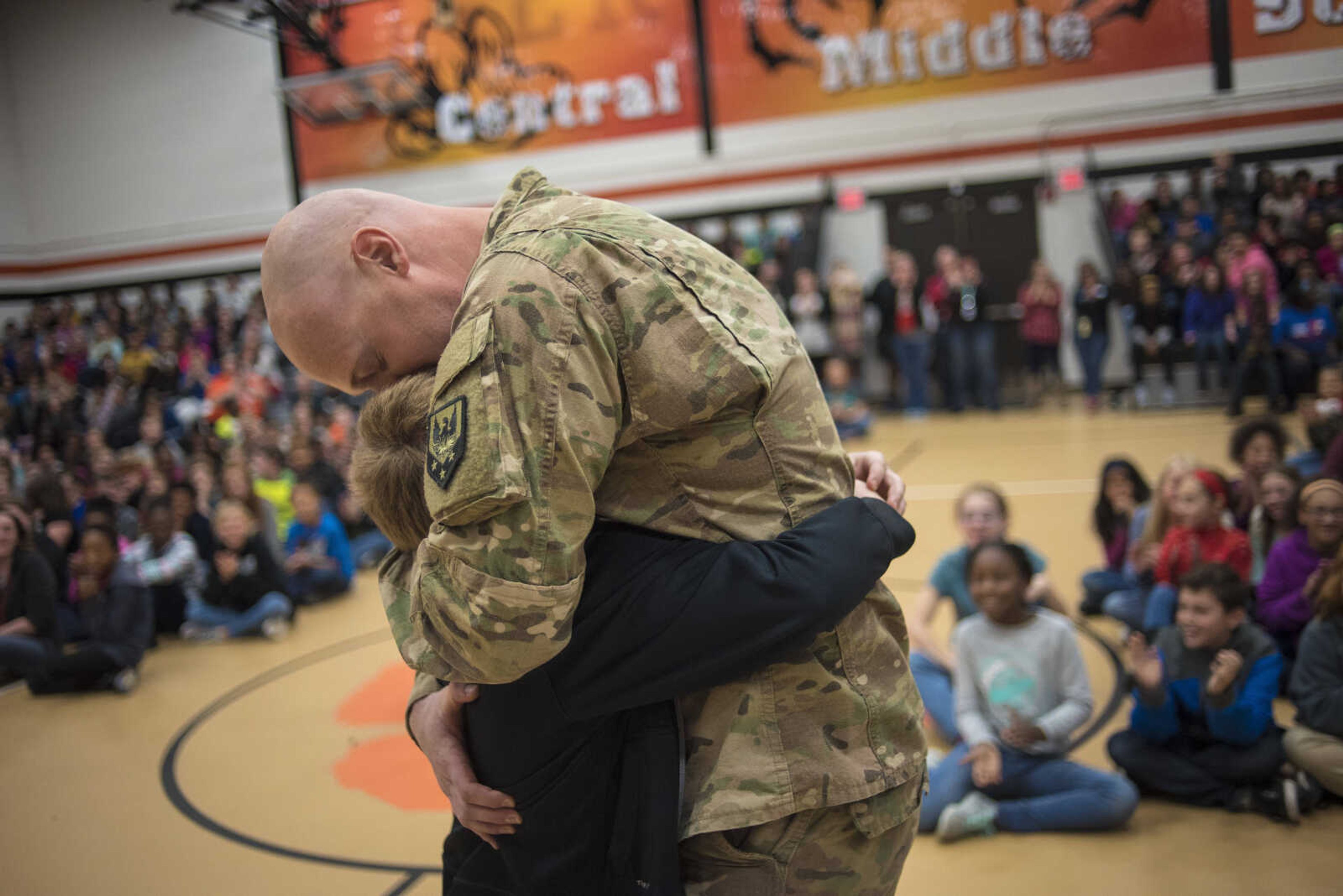 Staff Sgt. Michael Probst surprises his kids at school for the holidays