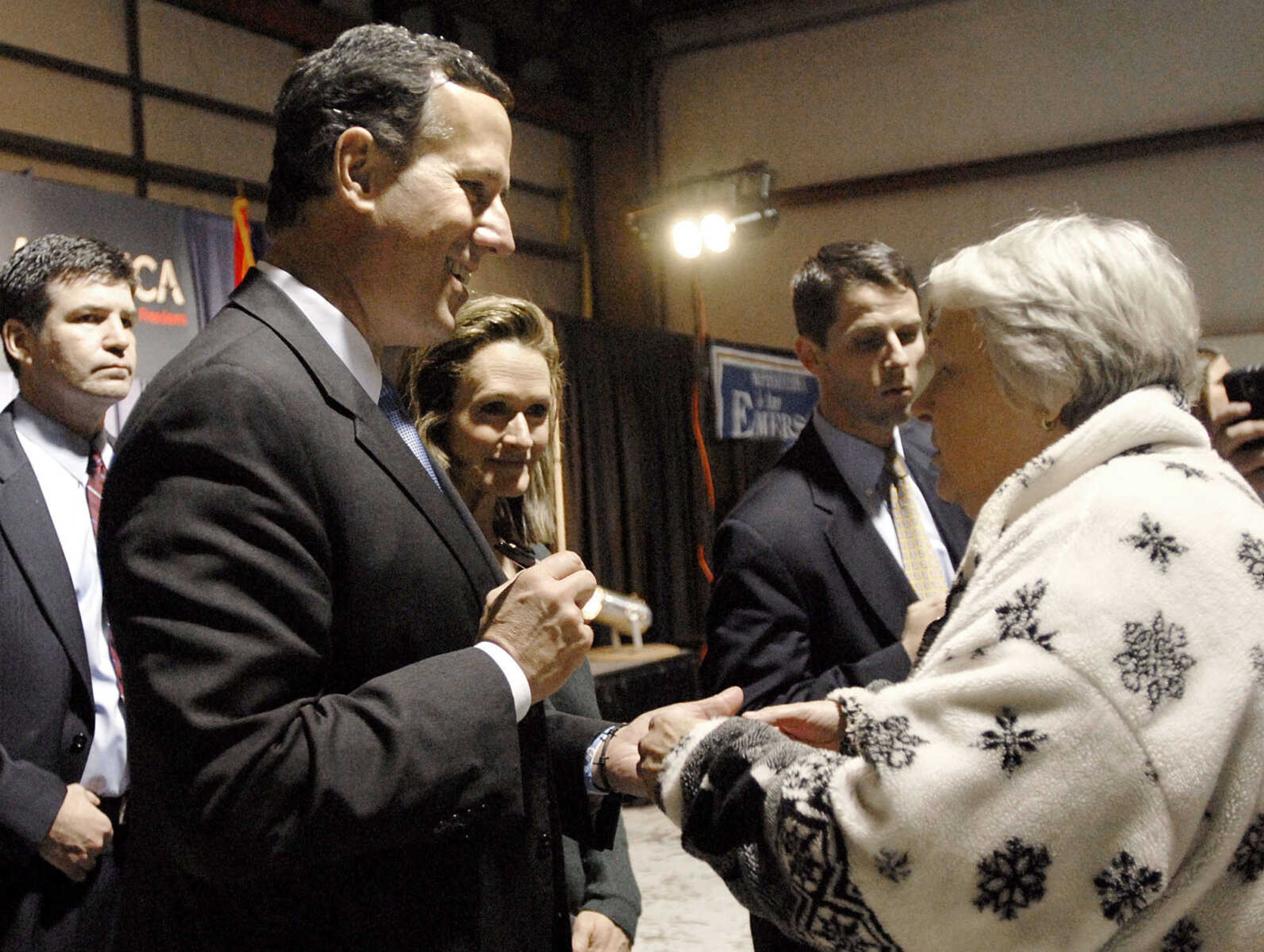 LAURA SIMON ~ lsimon@semissourian.com
Republican presidential candidate Rick Santorum autographs a campaign button for Dianne Maclin of Hayti, Mo. during his campaign stop at the Cape Girardeau Regional Airport Saturday night, March 10, 2012. Santorum was heading to Tupelo, Miss. following his stop in Cape Girardeau,Mo.