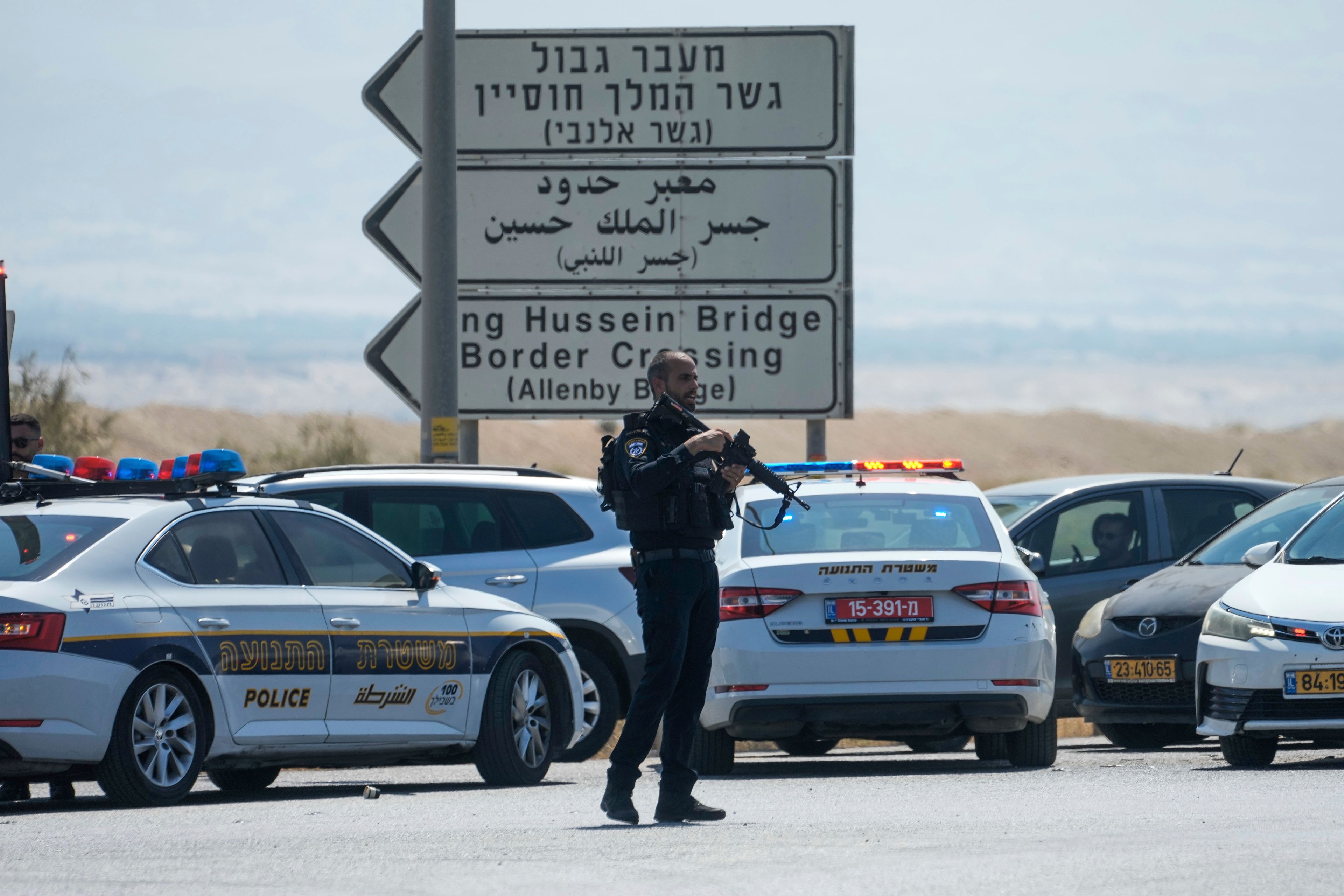 Israeli police stand guard near the site of a deadly shooting attack where Israeli officials say three people were shot and killed at the Allenby Bridge Crossing between the West Bank and Jordan, Sunday, Sept. 8, 2024. (AP Photo/Mahmoud Illean)