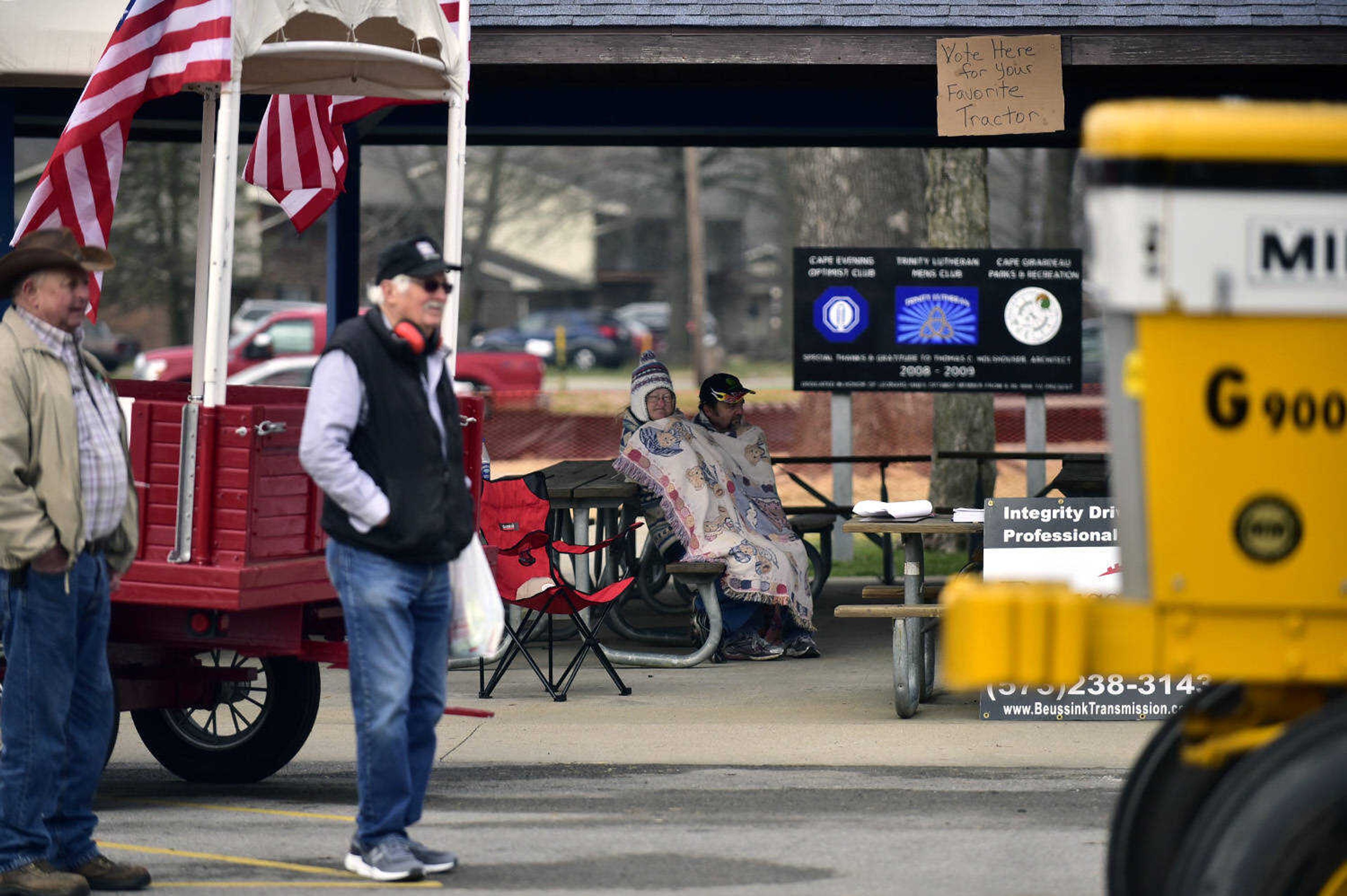 Brenda and Danny Thiele, back, sit wrapped up in a blanket to watch the tractor parade at the Cousin Carl Farm Show on Saturday, March 10, 2018, at Arena Park in Cape Girardeau.