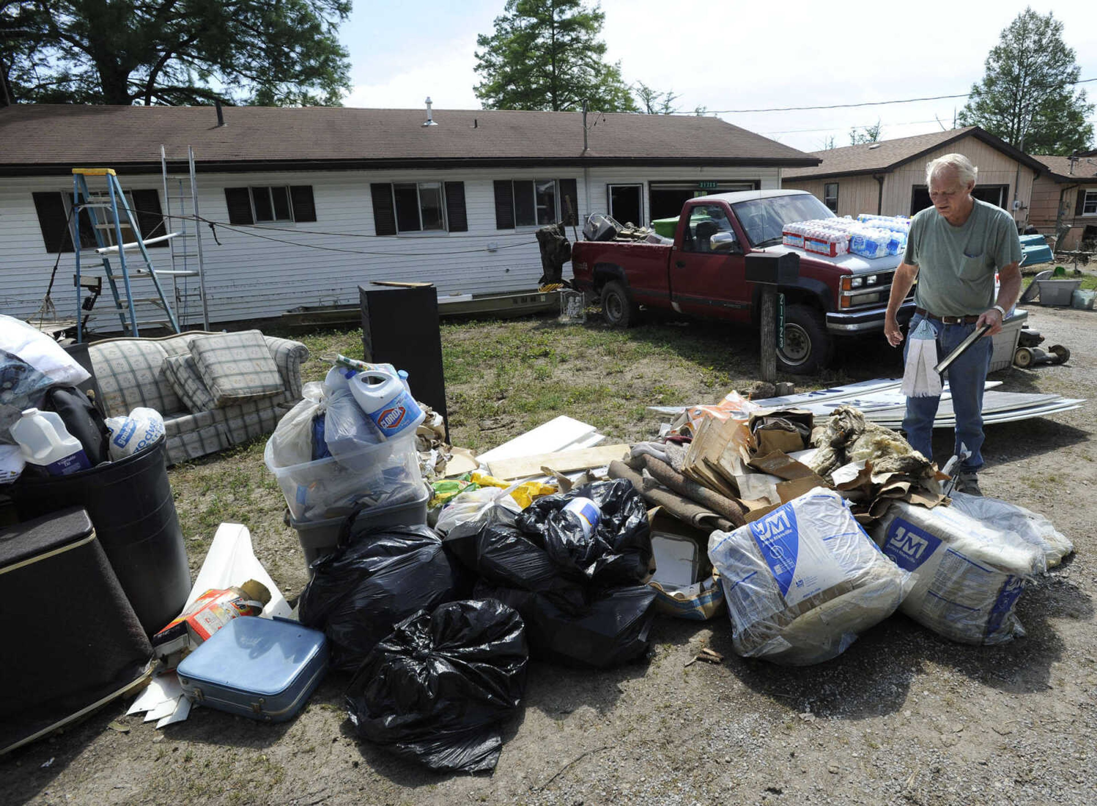 FRED LYNCH ~ flynch@semissourian.com
James Dunn works outside his house in the Mel Grah subdivision Thursday, May 12, 2011 after floodwaters receded from Horseshoe Lake near Olive Branch, Ill.