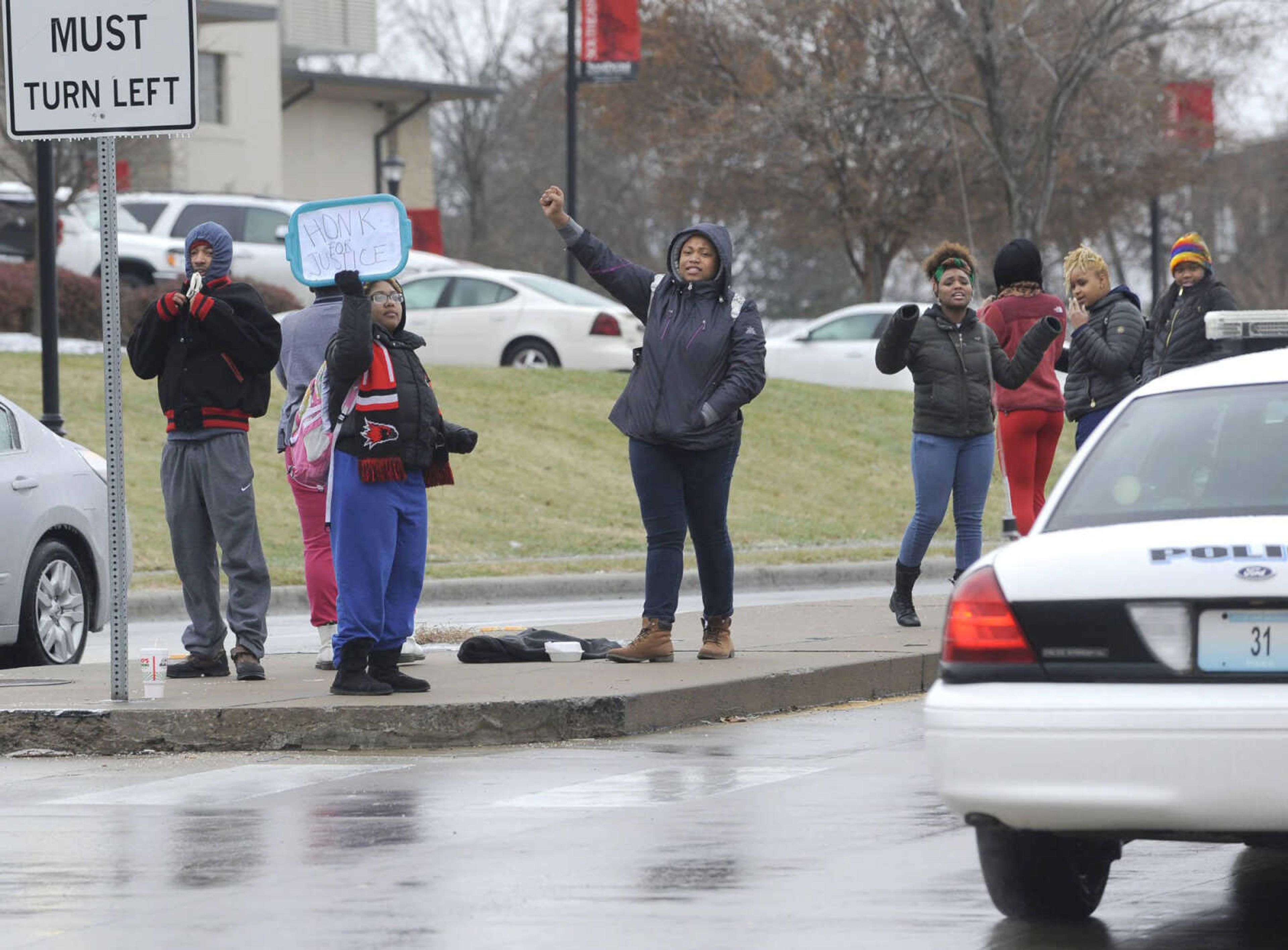 A small group of students shout slogans protesting recent events in Ferguson, Missouri on Monday, Dec. 1, 2014 at Henderson Avenue and Broadway in Cape Girardeau. (Fred Lynch)