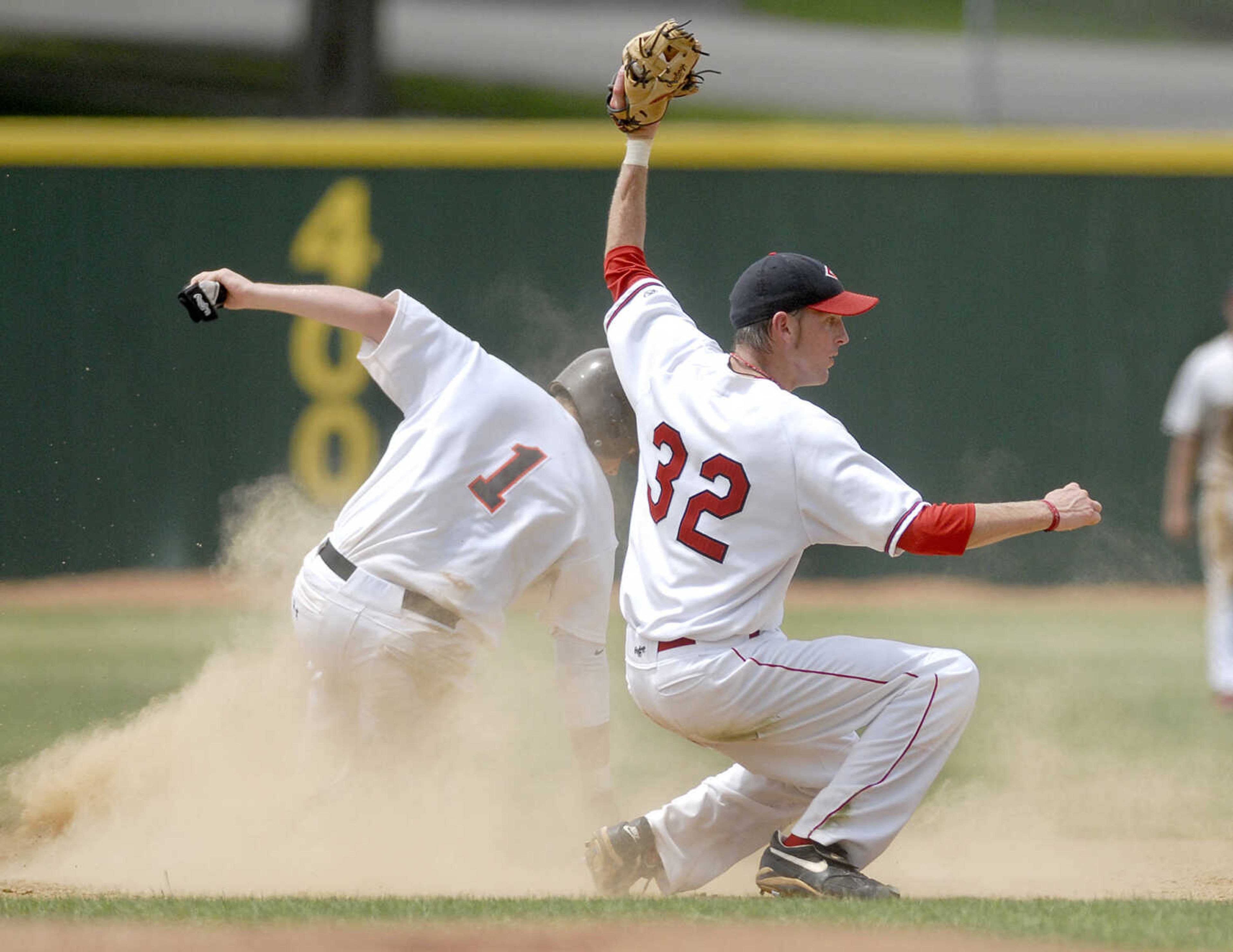 ELIZABETH DODD ~ edodd@semissourian.com
Capahas Denver Stuckey, right, attempts to tag out St. Louis Printers Adam Smith in the fourth inning Saturday at Capaha Field.