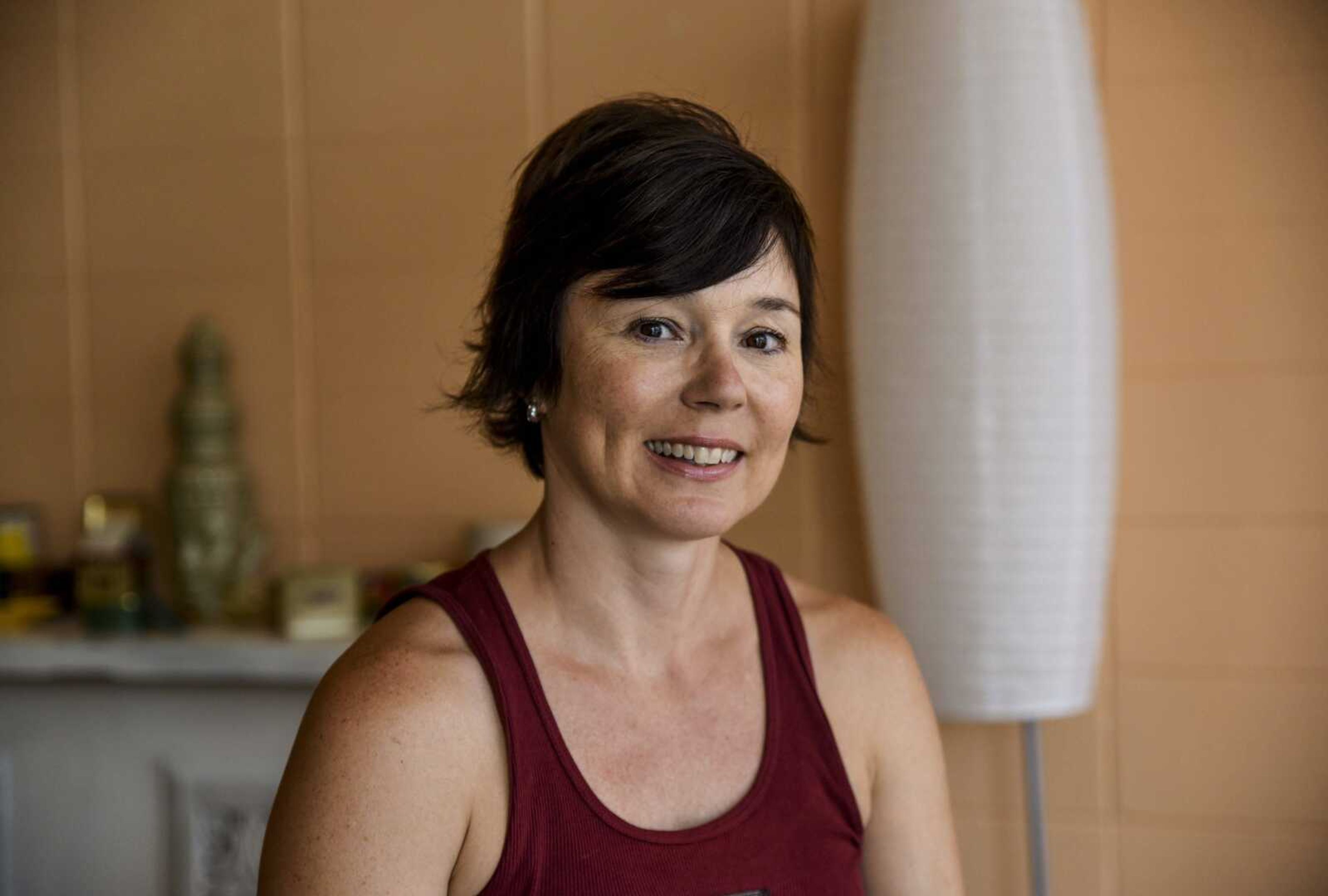 Sue Greenwood poses for a photo July 2 in the front room of Yoga East in Cape Girardeau.