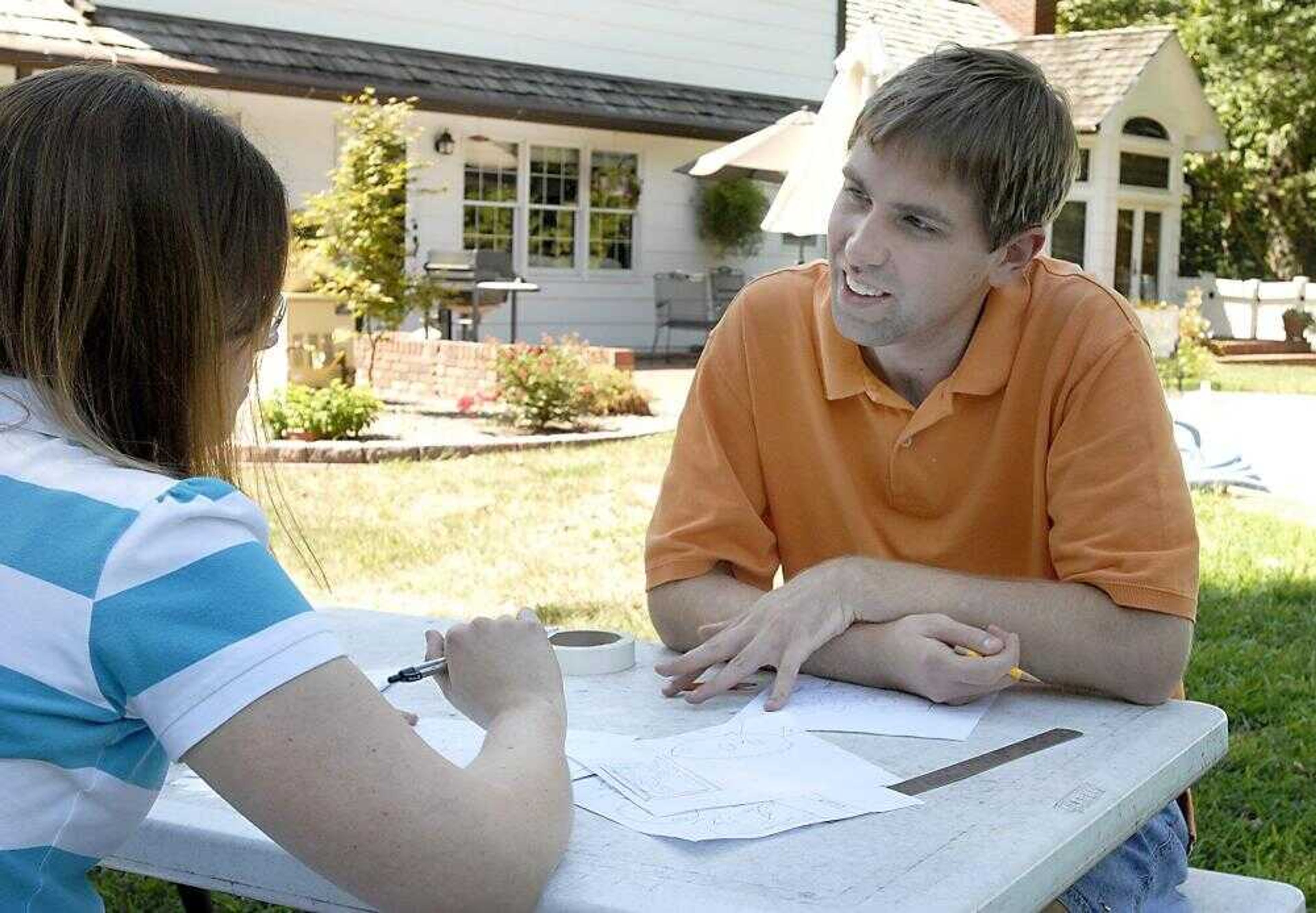 Taylor Crowe and Leah Ulrich discussed illustrations for the autism book they are working on at Crowe's home in Cape Girardeau on Monday, August 27, 2007. (Kit Doyle)