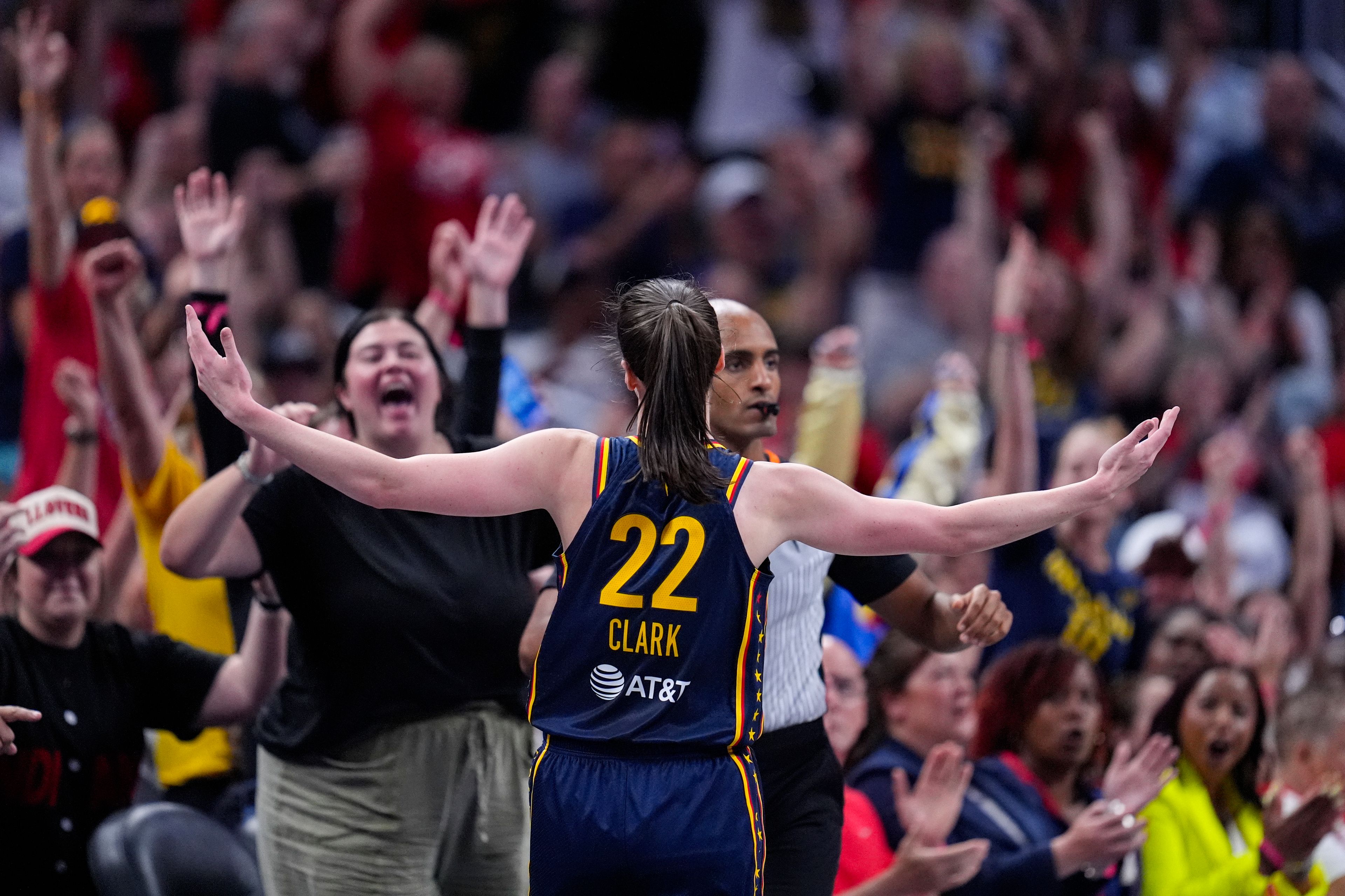 Indiana Fever guard Caitlin Clark (22) celebrates after a three-point basket against the Dallas Wings in the first half of a WNBA basketball game in Indianapolis, Sunday, Sept. 15, 2024. (AP Photo/Michael Conroy)