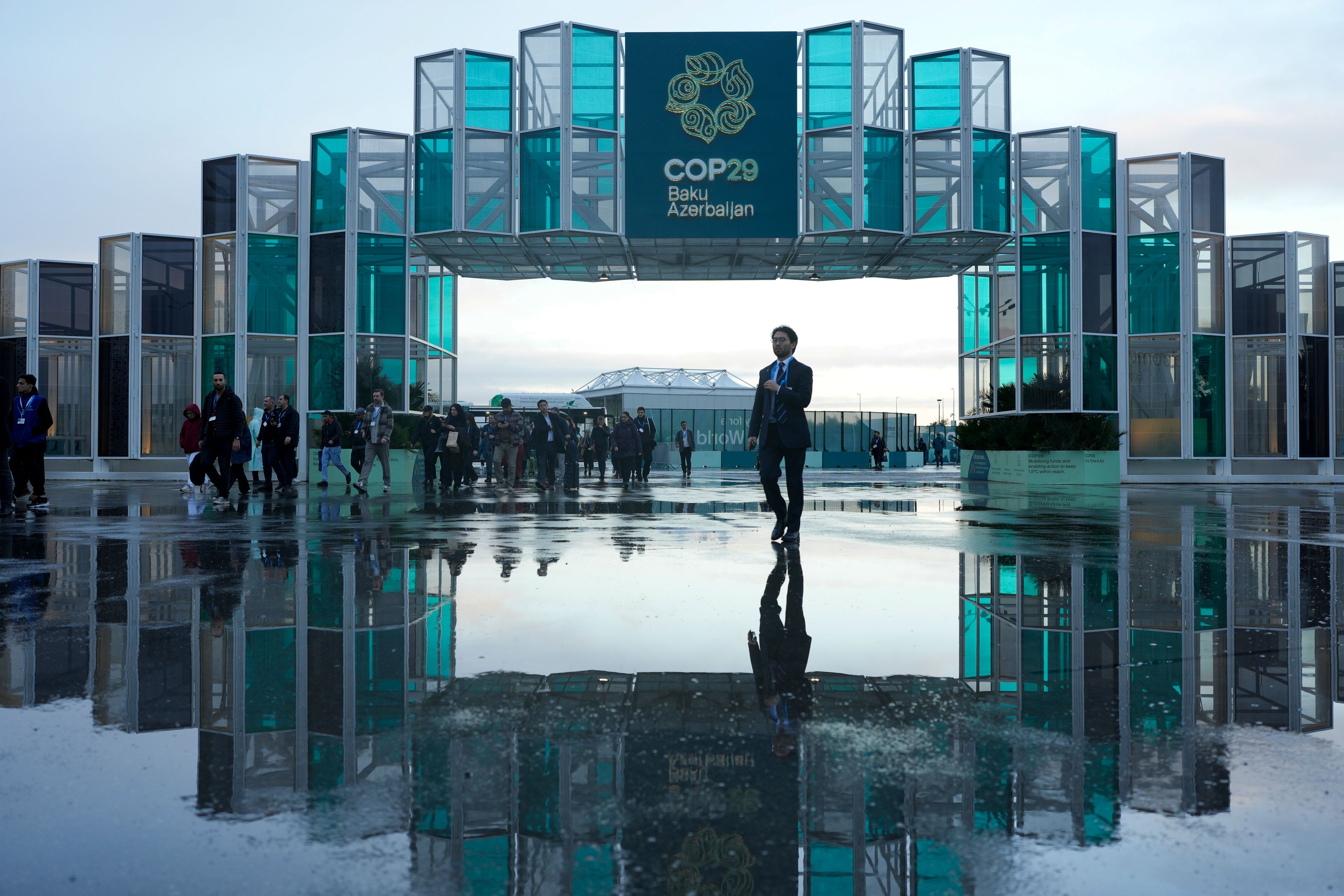 Attendees arrive for the day at the COP29 U.N. Climate Summit, Thursday, Nov. 14, 2024, in Baku, Azerbaijan. (AP Photo/Rafiq Maqbool)